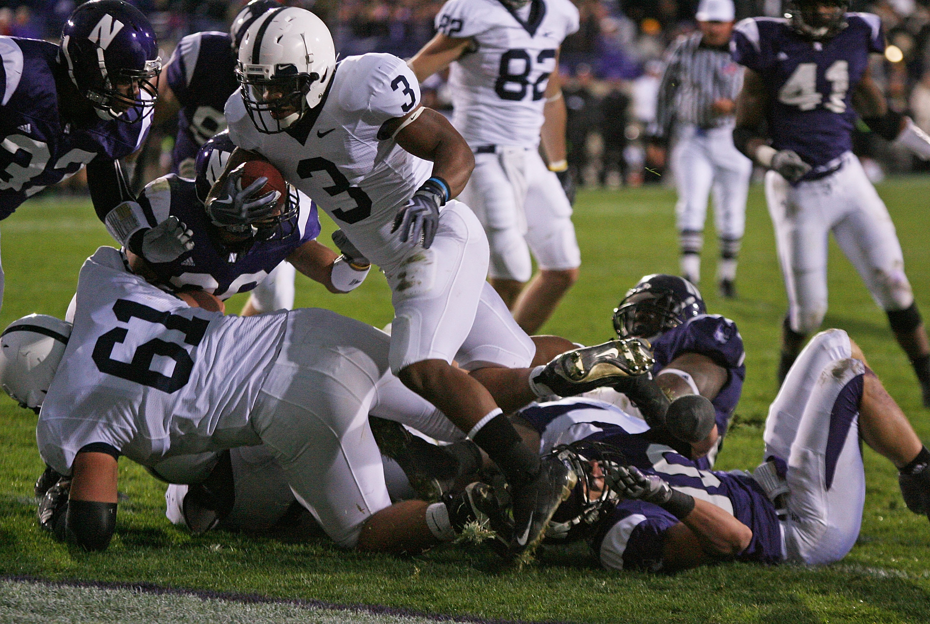 EVANSTON, IL - OCTOBER 31: Brandon Beachum #3 of the Penn State Nittany Lions hops over teammate Stefen Wisniewski #61 and Brian Peters #10 of the Northwestern Wildcats to score a touchdown at Ryan Field on October 31, 2009 in Evanston, Illinois. Penn Sta EVANSTON, IL - OCTOBER 31: Brandon Beachum #3 of the Penn State Nittany Lions hops over teammate Stefen Wisniewski #61 and Brian Peters #10 of the Northwestern Wildcats to score a touchdown at Ryan Field on October 31, 2009 in Evanston, Illinois. Penn Sta