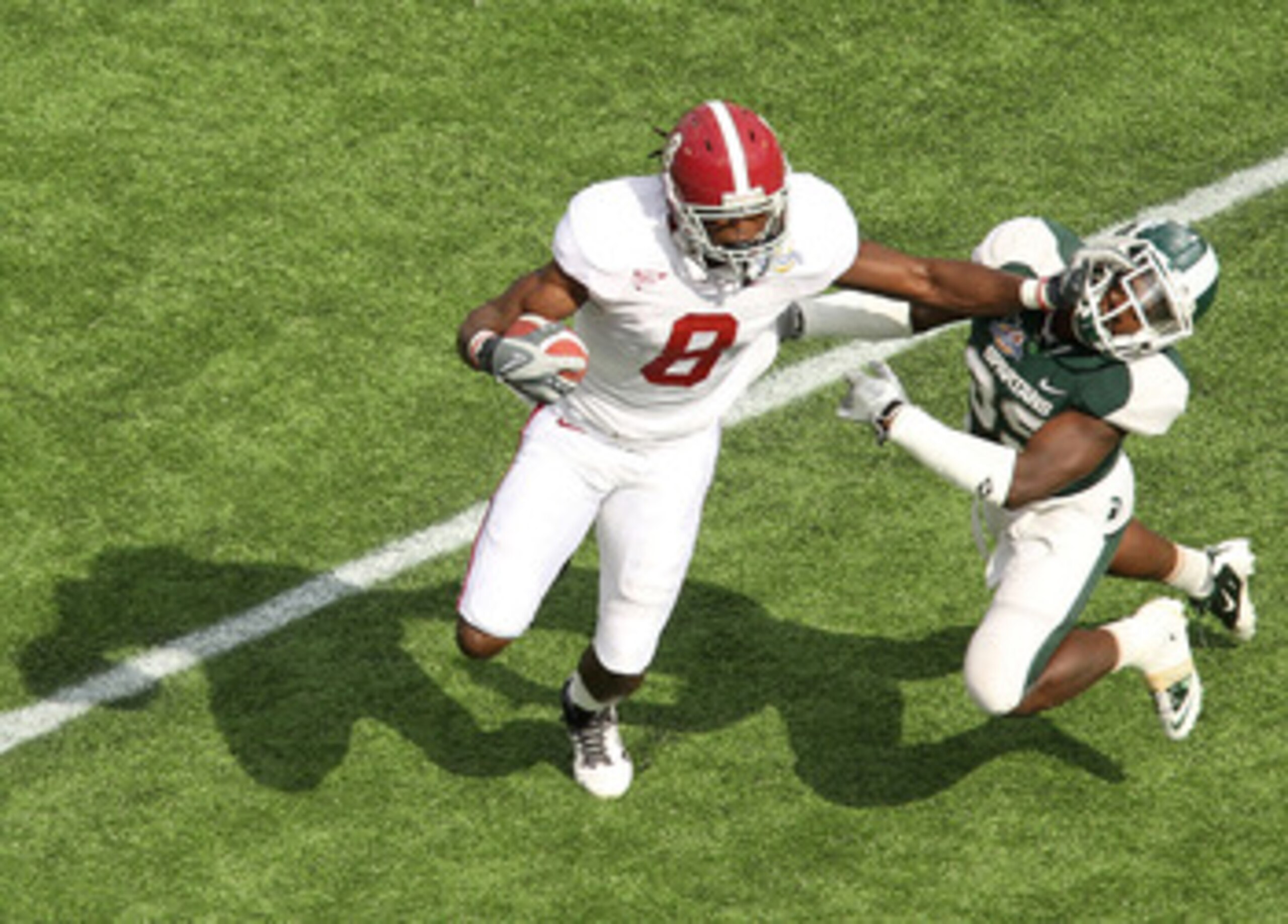 ORLANDO, FL - JANUARY 01: Julio Jones #8 of the Alabama Crimson Tide stiffarms Chris Rucker #29 of the Michigan State Spartans during the Capitol One Bowl at the Florida Citrus Bowl on January 1, 2011 in Orlando, Florida. (Photo by Mike Ehrmann/Getty Im ORLANDO, FL - JANUARY 01: Julio Jones #8 of the Alabama Crimson Tide stiffarms Chris Rucker #29 of the Michigan State Spartans during the Capitol One Bowl at the Florida Citrus Bowl on January 1, 2011 in Orlando, Florida. (Photo by Mike Ehrmann/Getty Im