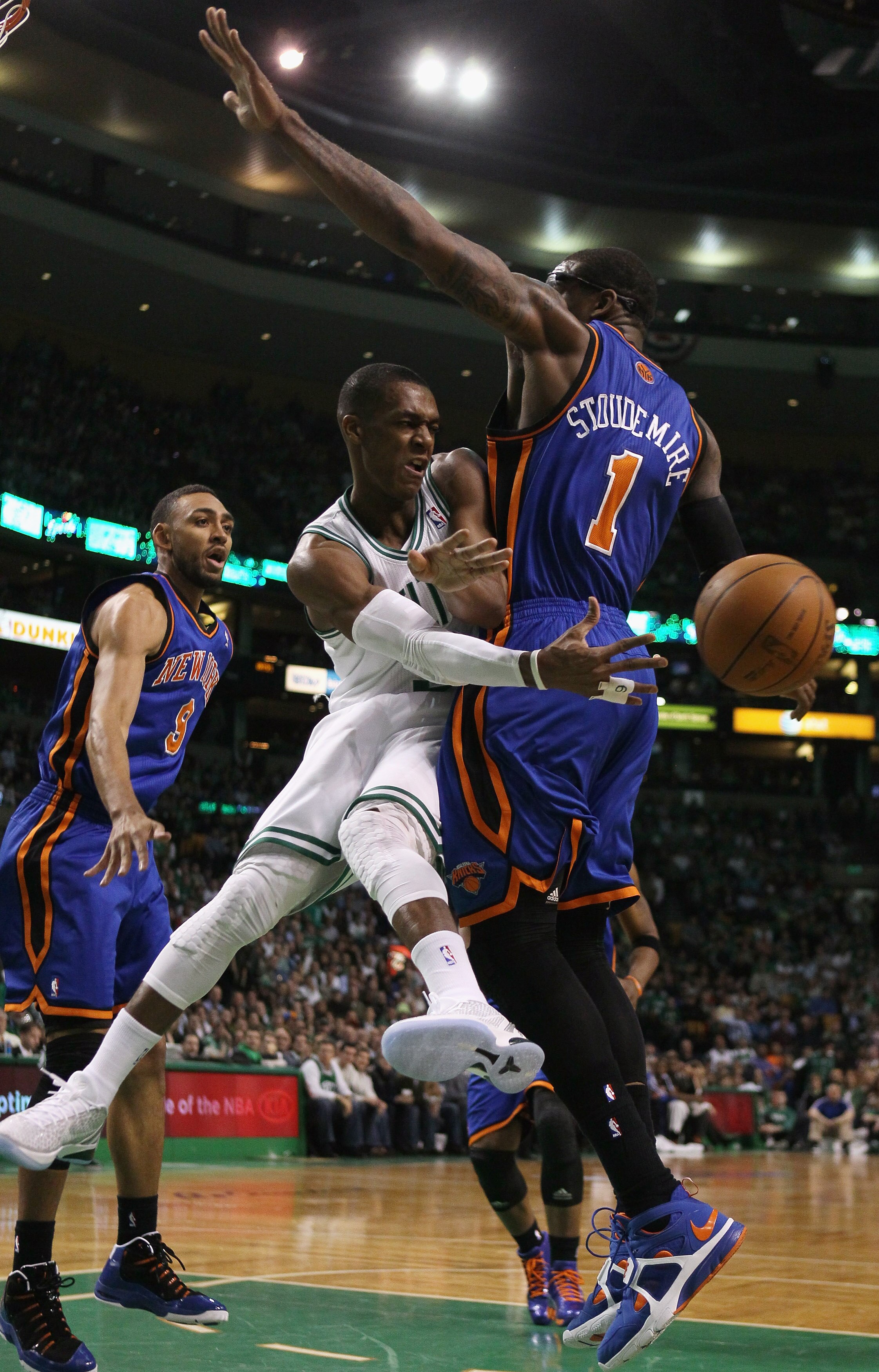 BOSTON, MA - APRIL 19:  Rajon Rondo #9 of the Boston Celtics passes the ball around Amare Stoudemire #1 of the New York Knicks in Game Two of the Eastern Conference Quarterfinals in the 2011 NBA Playoffs on April 19, 2011 at the TD Garden in Boston, Massa
