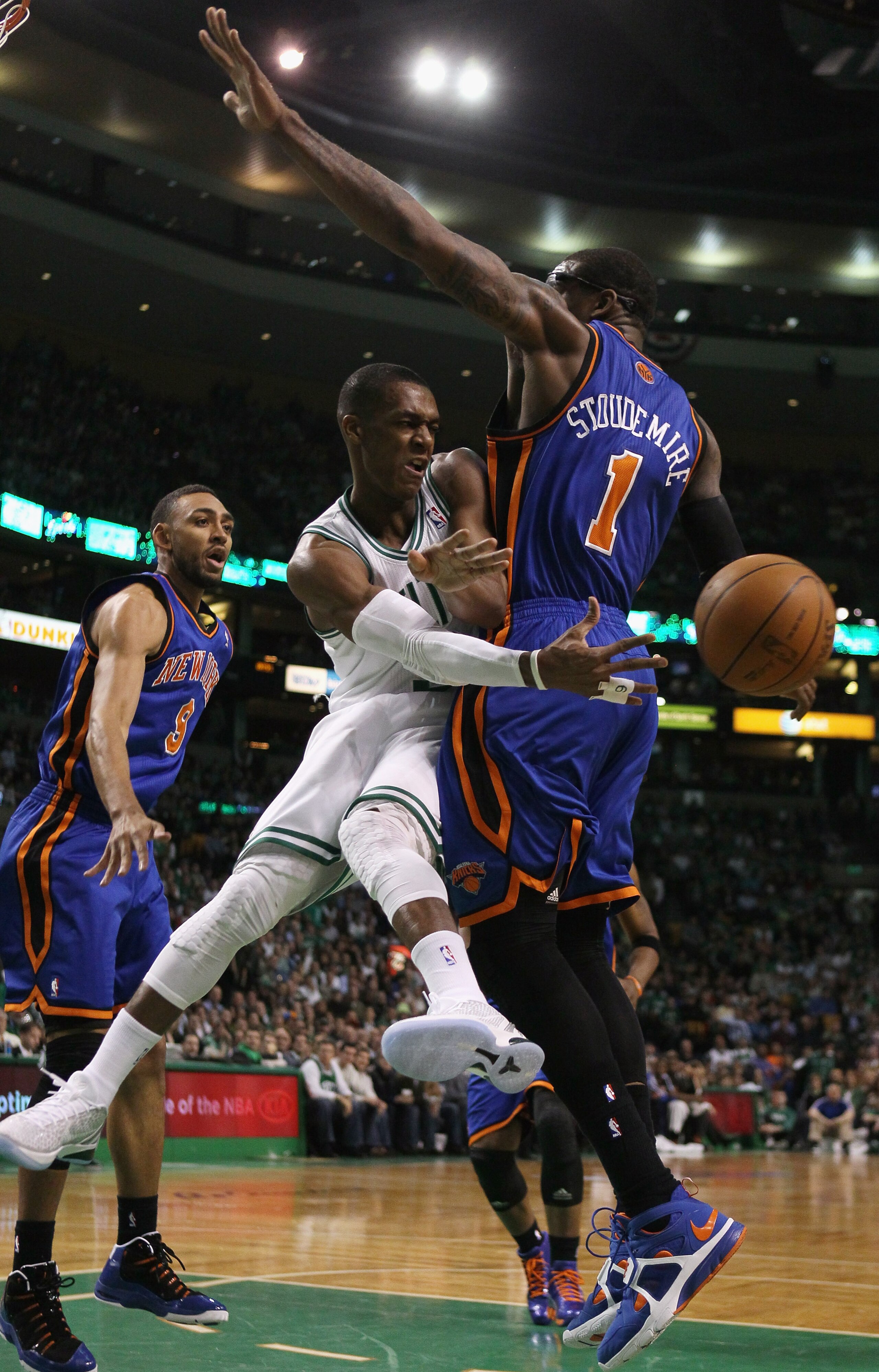 BOSTON, MA - APRIL 19:  Rajon Rondo #9 of the Boston Celtics passes the ball around Amare Stoudemire #1 of the New York Knicks in Game Two of the Eastern Conference Quarterfinals in the 2011 NBA Playoffs on April 19, 2011 at the TD Garden in Boston, Massa