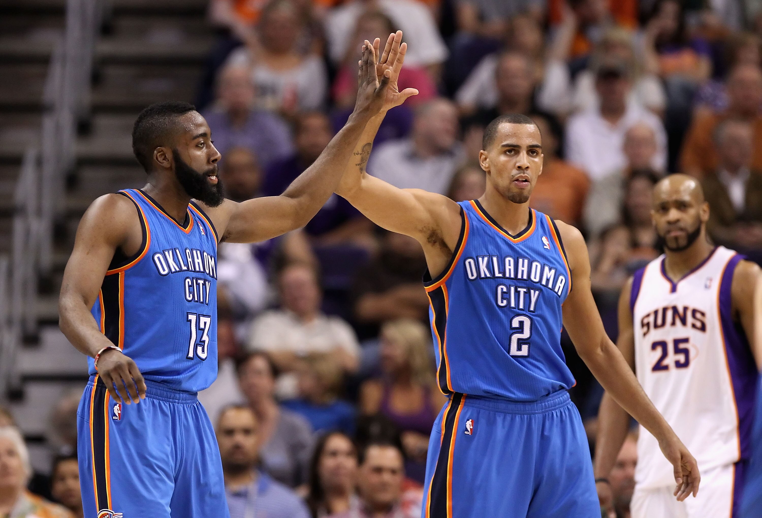 PHOENIX, AZ - MARCH 30:  James Harden #13 of the Oklahoma City Thunder high fives teamate Thabo Sefolosha #2 after scoring against the Phoenix Suns during the NBA game at US Airways Center on March 30, 2011 in Phoenix, Arizona. The Thunder defeated the Su