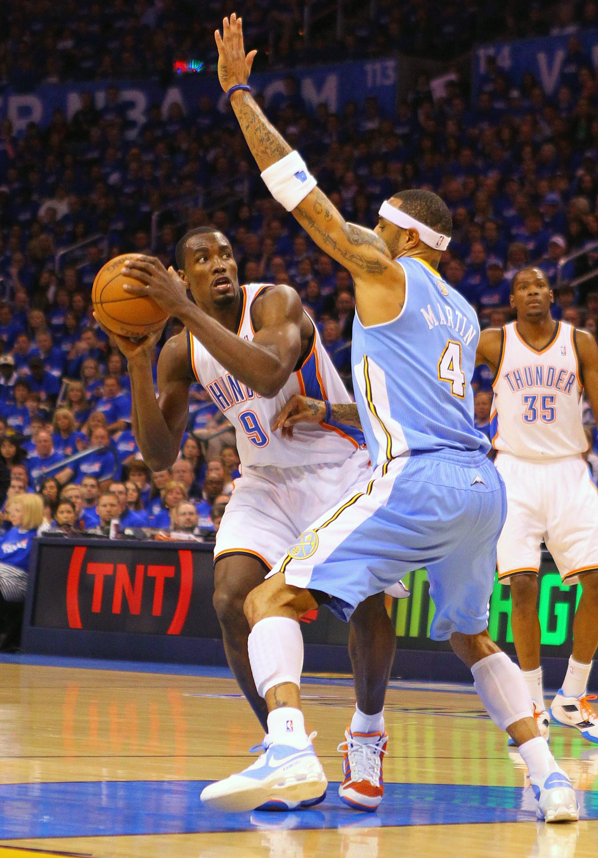 OKLAHOMA CITY, OK - APRIL 20: Serge Ibaka #9 of the Oklahoma City Thunder looks to get past Kenyon Martin #4 of the Denver Nuggets in Game Two of the Western Conference Quarterfinals in the 2011 NBA Playoffs on April 20, 2011 at the Ford Center in Oklahom
