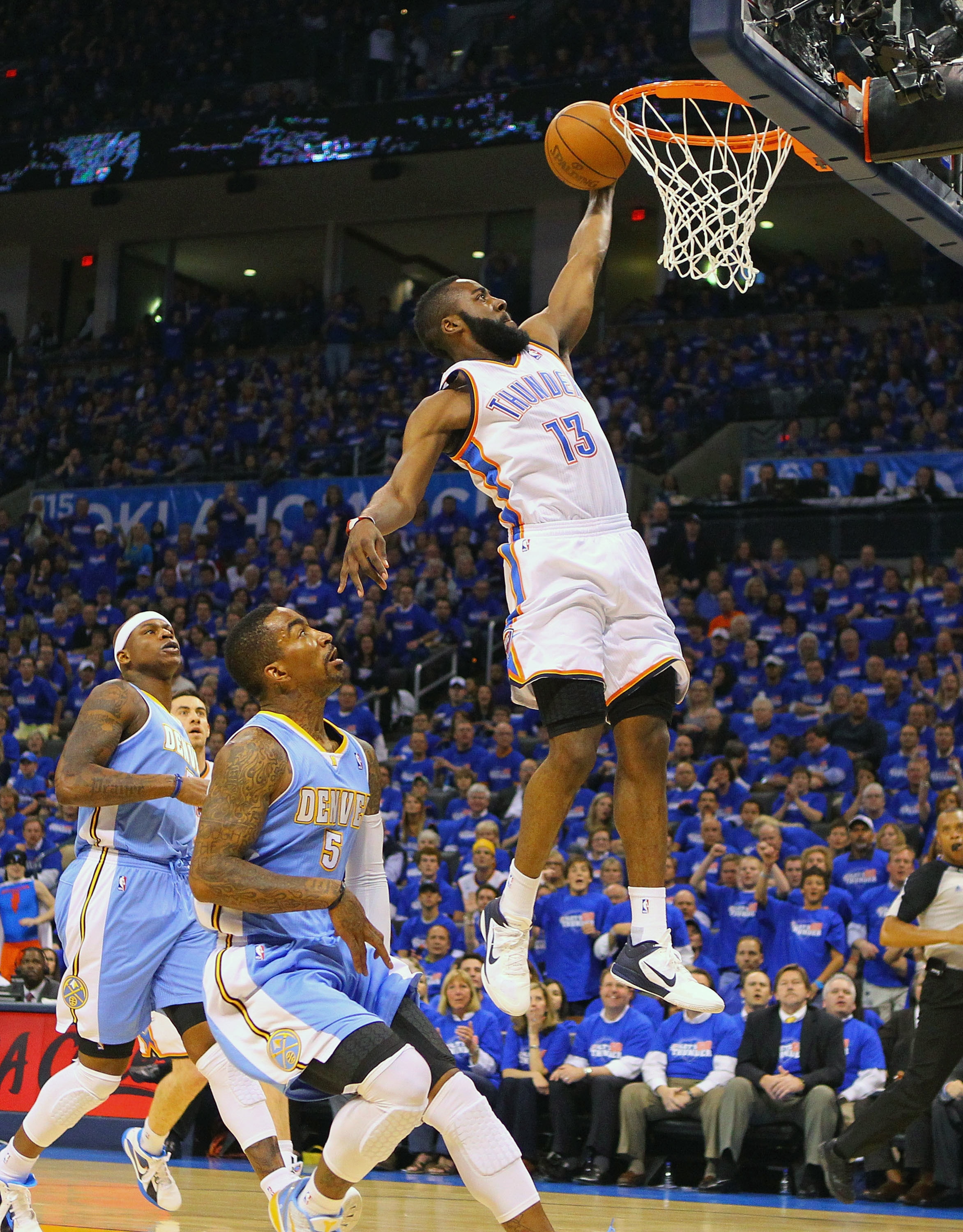 OKLAHOMA CITY, OK - APRIL 20: James Harden #13 of the Oklahoma City Thunder dunks the ball against J.R. Smith #5 of the Denver Nuggets in Game Two of the Western Conference Quarterfinals in the 2011 NBA Playoffs on April 20, 2011 at the Ford Center in Okl