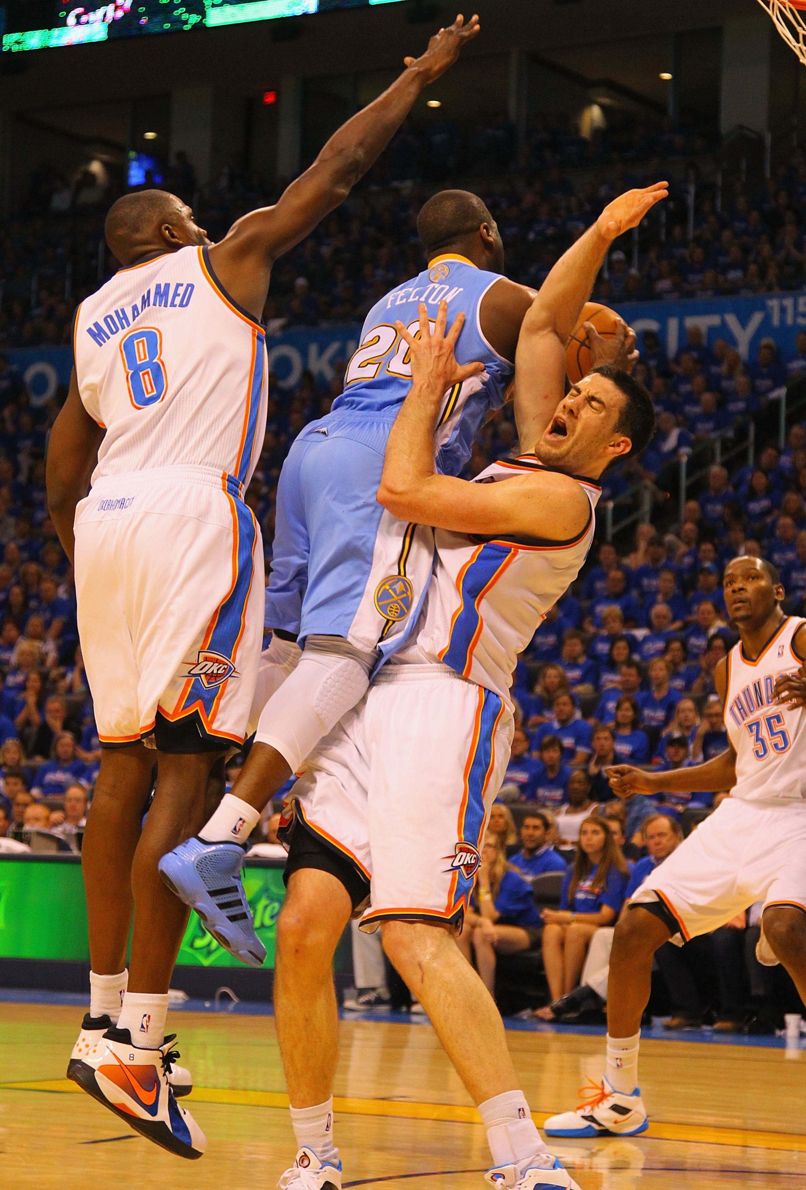 OKLAHOMA CITY, OK - APRIL 17: Nick Collison #4 of the Oklahoma City Thunder draws a fouls against Raymond Felton #20 of the Denver Nuggets in Game One of the Western Conference Quarterfinals in the 2011 NBA Playoffs on April 17, 2011 at the Ford Center in