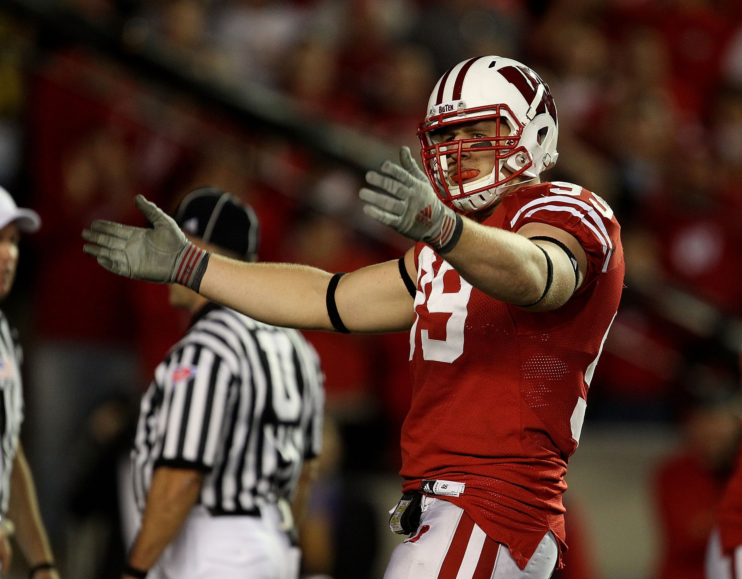 MADISON, WI - OCTOBER 16: J.J. Watt #99 of the Wisconsin Badgers encourages the crowd during a game against the Ohio State Buckeyes at Camp Randall Stadium on October 16, 2010 in Madison, Wisconsin. Wisconsin defeated Ohio State 31-18. (Photo by Jonathan MADISON, WI - OCTOBER 16: J.J. Watt #99 of the Wisconsin Badgers encourages the crowd during a game against the Ohio State Buckeyes at Camp Randall Stadium on October 16, 2010 in Madison, Wisconsin. Wisconsin defeated Ohio State 31-18. (Photo by Jonathan
