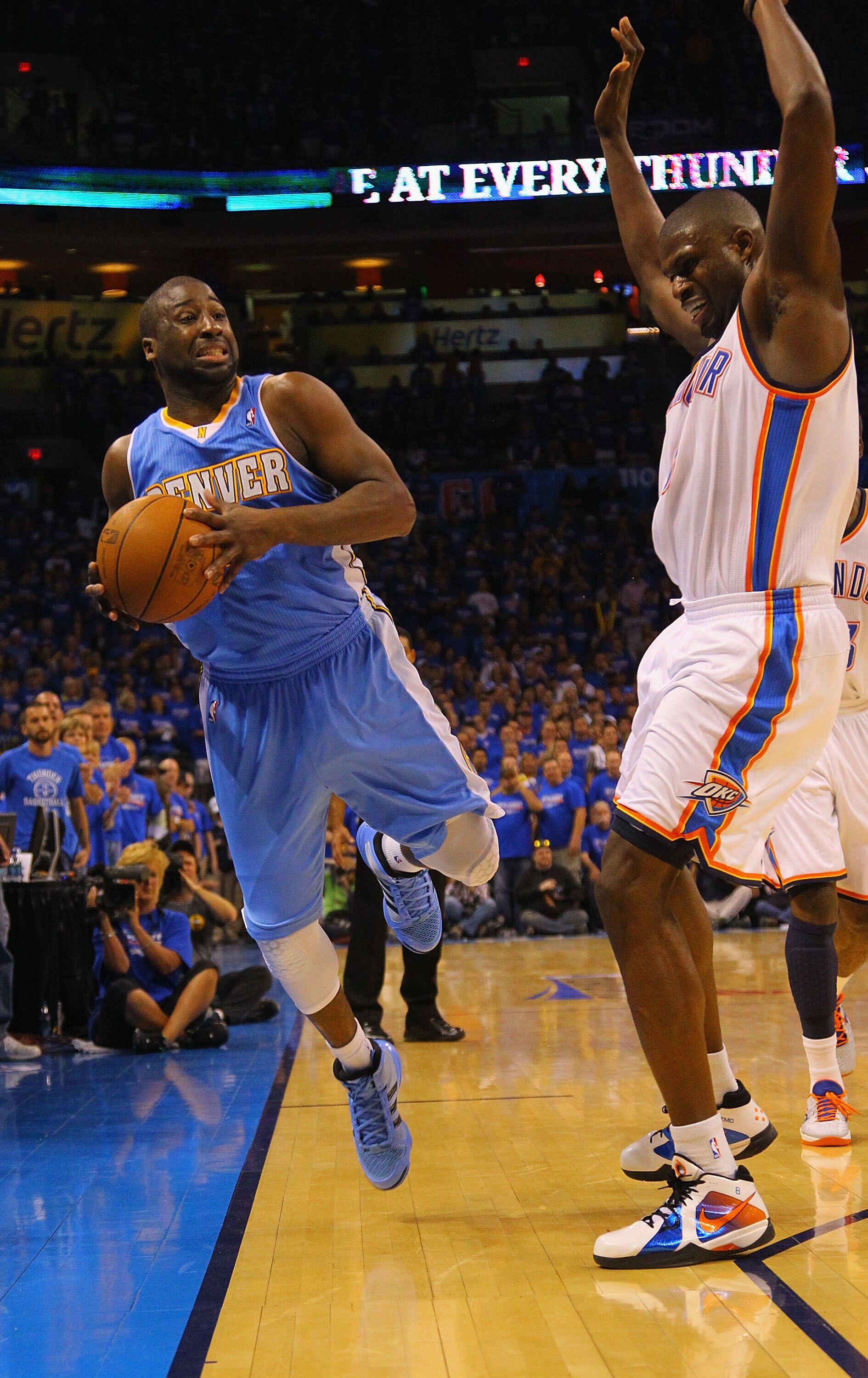OKLAHOMA CITY, OK - APRIL 17: Raymond Felton #20 of the Denver Nuggets is pushed out of bounds by Nazr Mohammed #8 of the Oklahoma City Thunder in Game One of the Western Conference Quarterfinals in the 2011 NBA Playoffs on April 17, 2011 at the Ford Cent