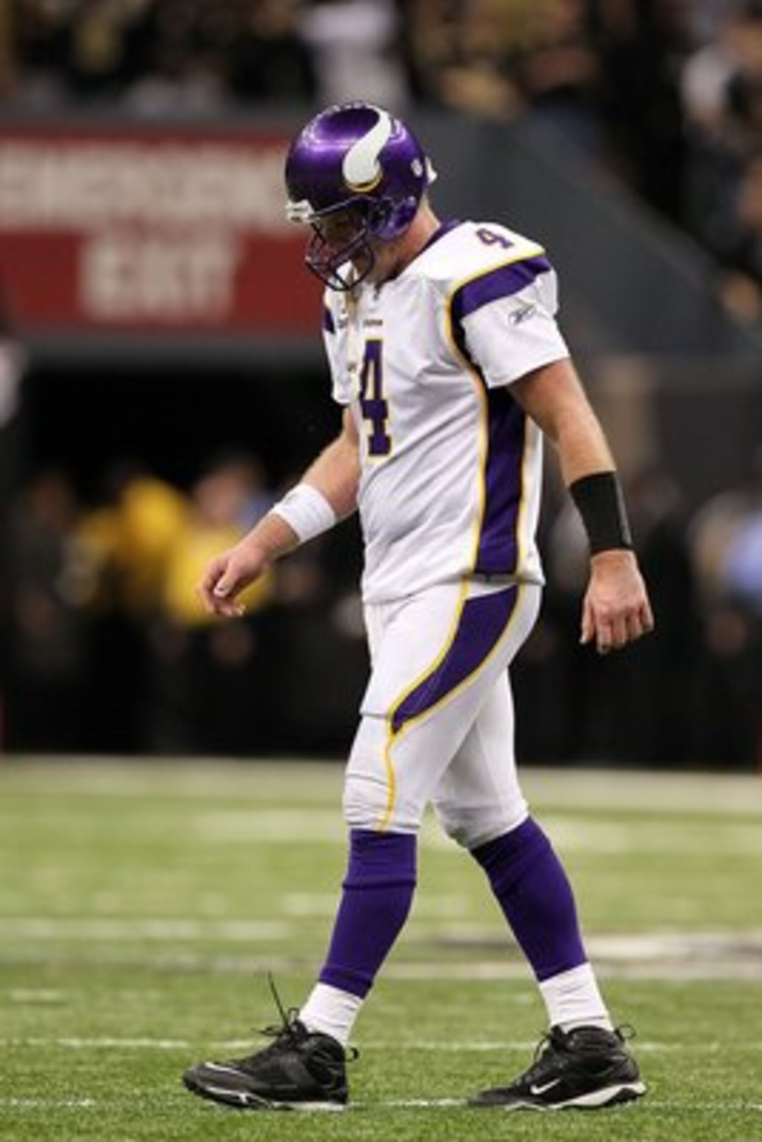 NEW ORLEANS - JANUARY 24:  Quarterback Brett Favre #4 of the Minnesota Vikings walks towards the sidelin with his head down against the New Orleans Saints during the NFC Championship Game at the Louisiana Superdome on January 24, 2010 in New Orleans, Loui
