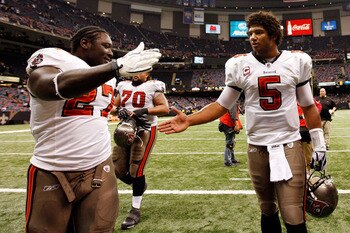 NEW ORLEANS, LA - JANUARY 02:  Quarterback Josh Freeman #5  celebrates with LeGarrette Blount #27 of the Tampa Bay Buccaneers after defeating the New Orleans Saints 23-13 at the Louisiana Superdome on January 2, 2011 in New Orleans, Louisiana.   (Photo by