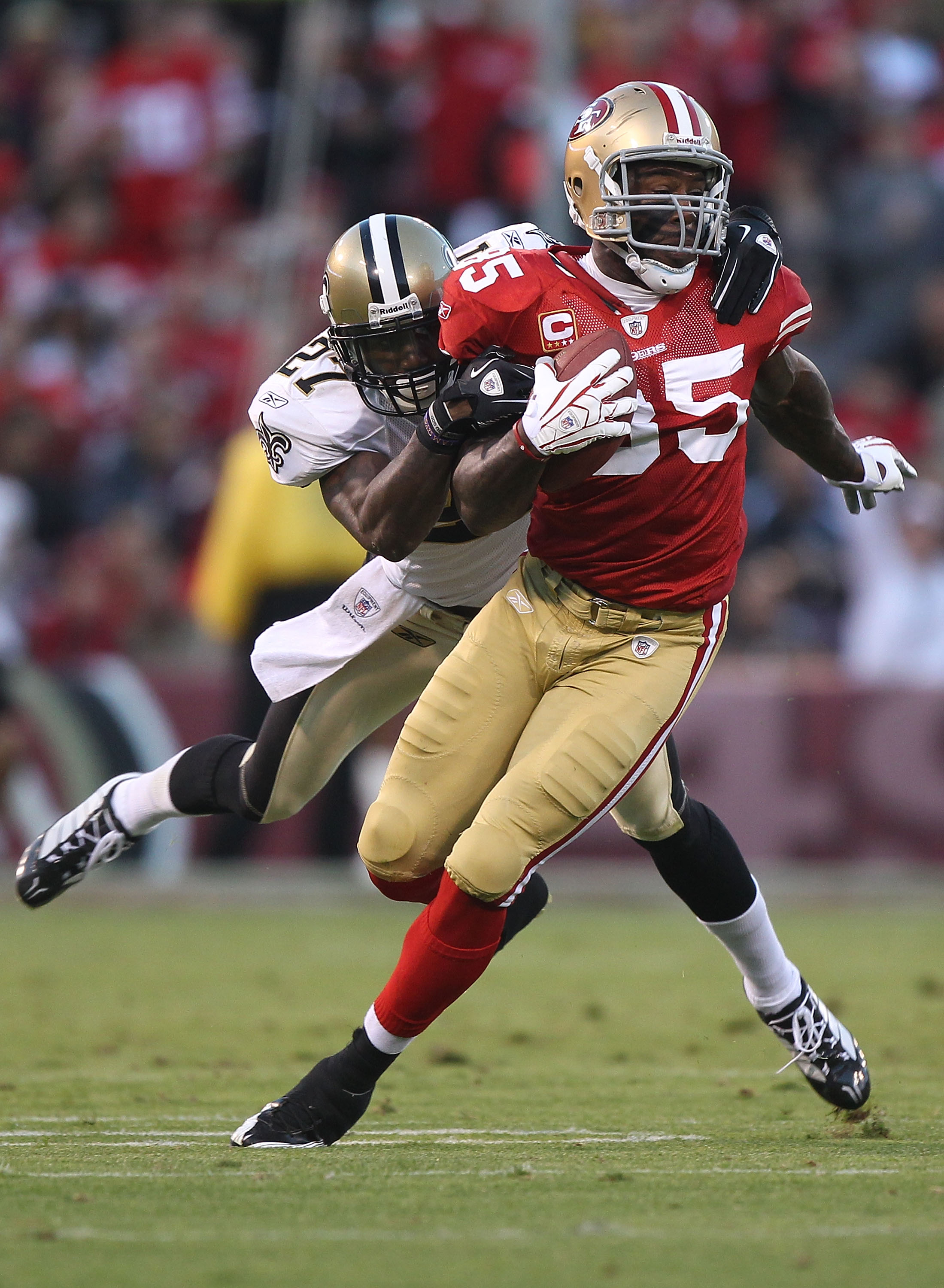 SAN FRANCISCO - SEPTEMBER 20:  Vernon Davis #85 of the San Francisco 49er runs after a catch against Malcolm Jenkins #27 of the New Orleans Saints during an NFL game at Candlestick Park on September 20, 2010 in San Francisco, California.(Photo by Jed Jaco