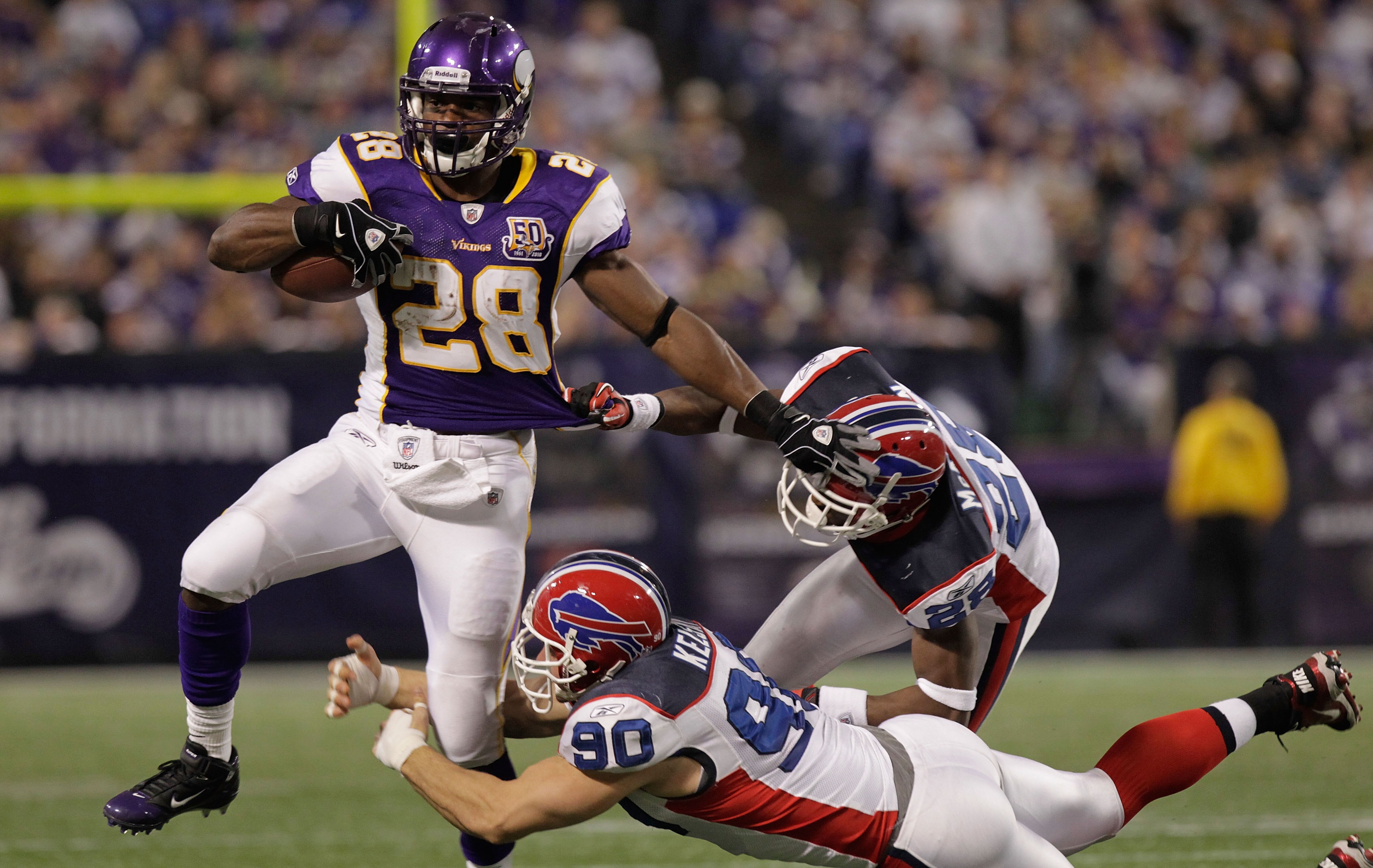 MINNEAPOLIS, MN - DECEMBER 05:  Adrian Peterson #28 of the Minnesota Vikings is tackled by Chris Kelsay #90 of the Buffalo Bills at the Mall of America Field at the Hubert H. Humphrey Metrodome on December 5, 2010 in Minneapolis, Minnesota.  (Photo by Nic
