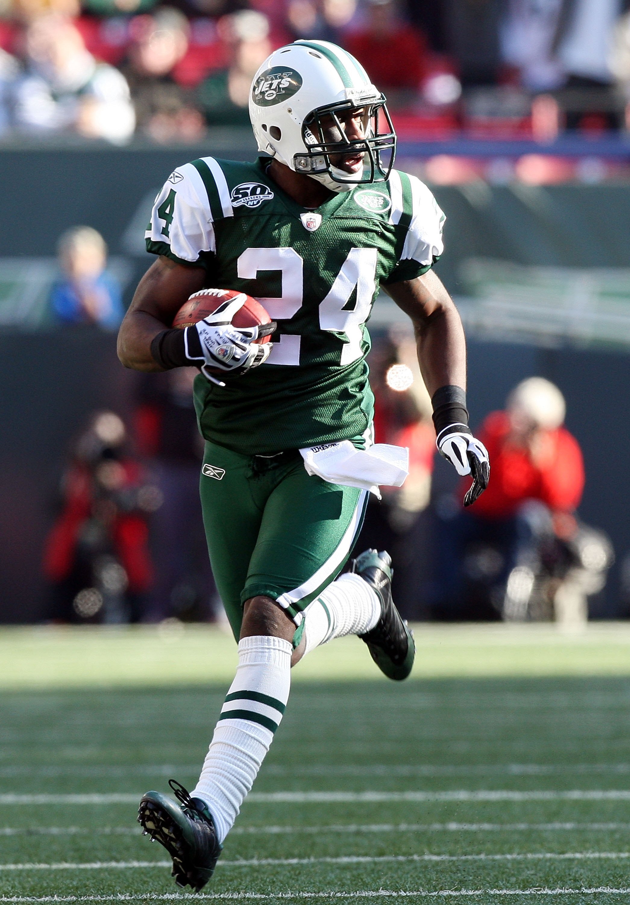 EAST RUTHERFORD, NJ - NOVEMBER 29:  Darrelle Revis #24 of the New York Jets runs the ball in for a first quarter touchdown after an interception against the Carolina Panthers on November 29, 2009 at Giants Stadium in East Rutherford, New Jersey.  (Photo b