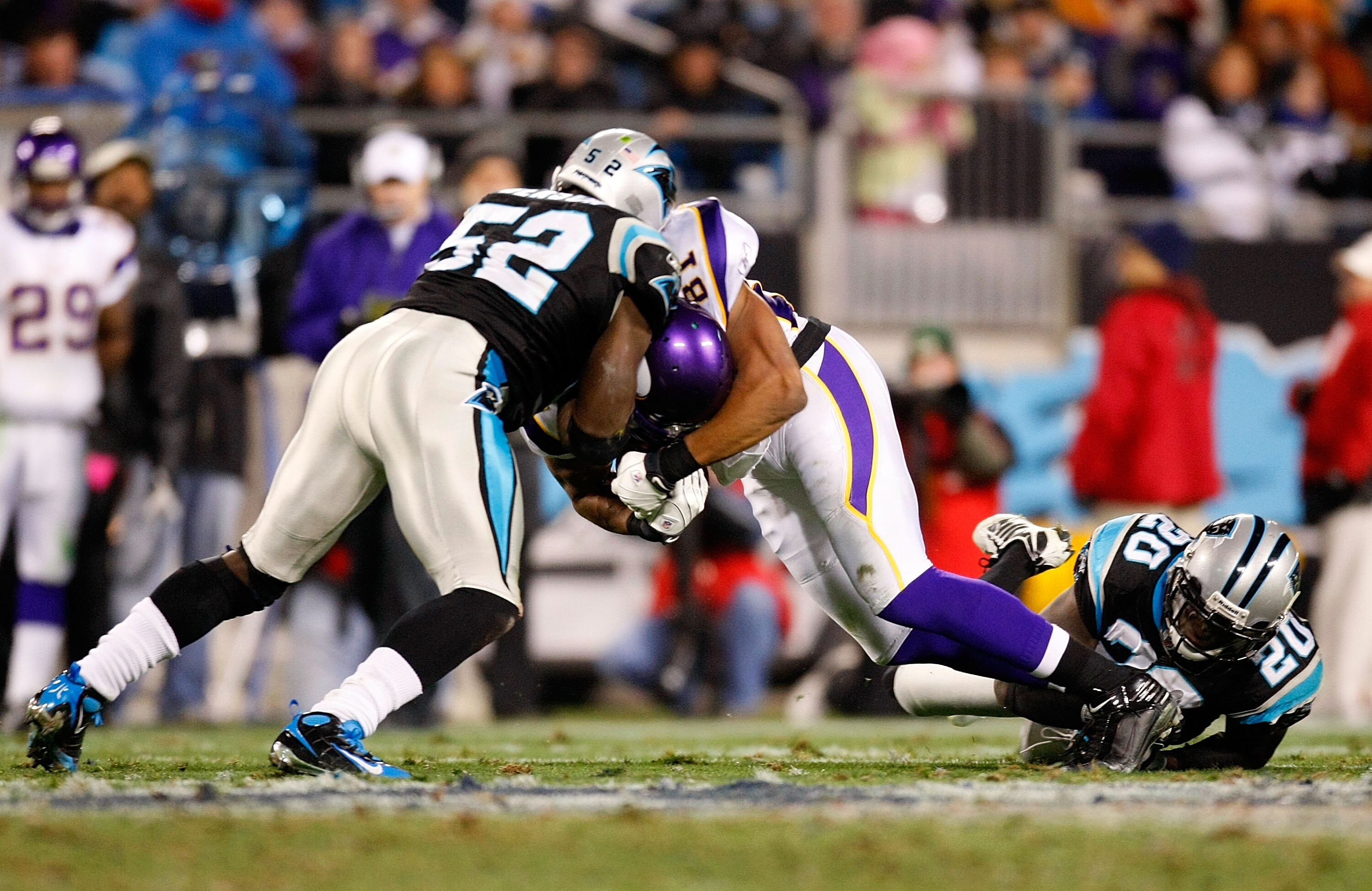 CHARLOTTE, NC - DECEMBER 20:  Visanthe Shiancoe #81 of the Minnesota Vikings is tackled by Jon Beason #52 and Chris Gamble #20 of the Carolina Panthers at Bank of America Stadium on December 20, 2009 in Charlotte, North Carolina.  (Photo by Kevin C. Cox/G