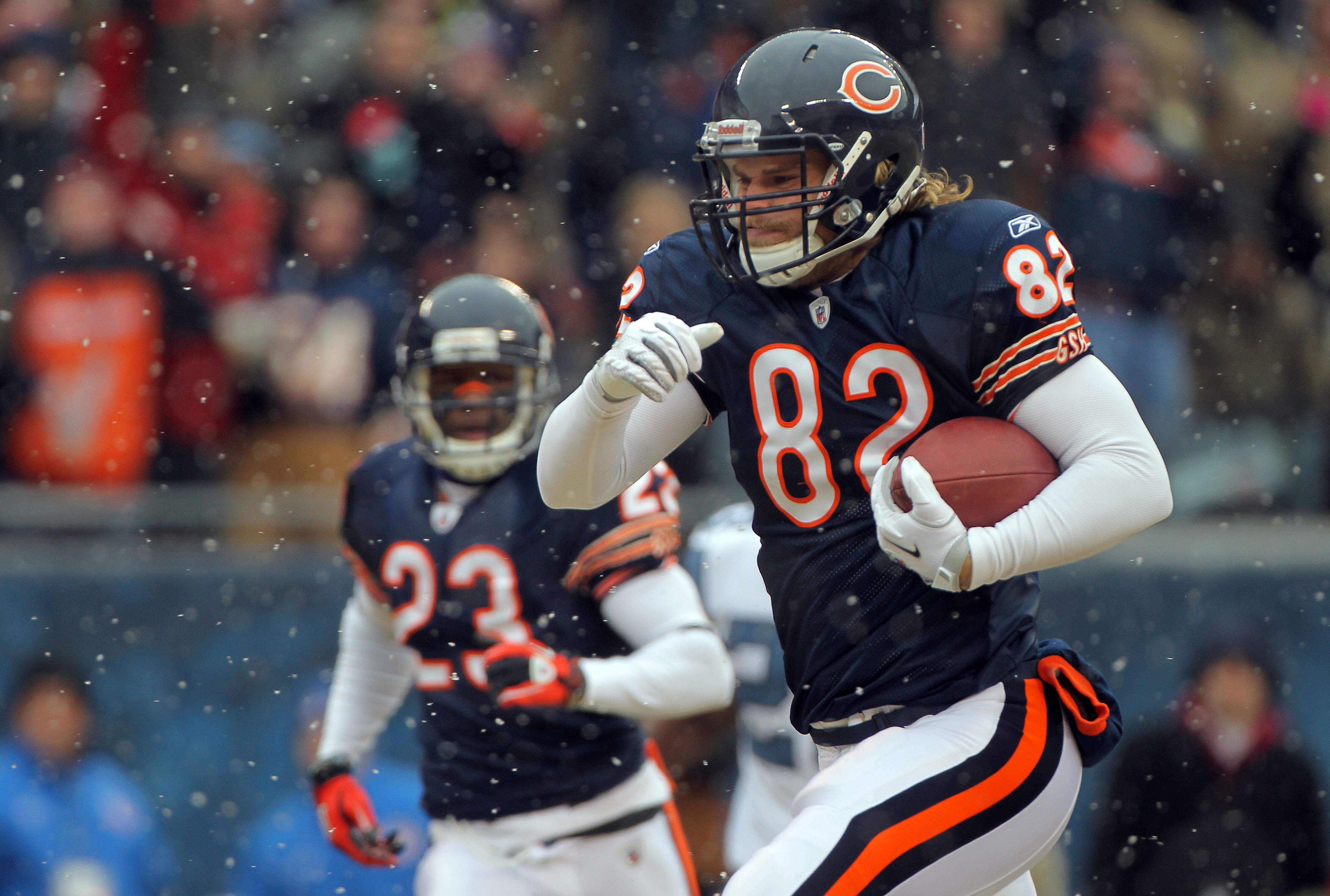 CHICAGO, IL - JANUARY 16:  Tight end Greg Olsen #82 of the Chicago Bears runs after he catches a 58-yard touchdown in the first quarter in front of Lawyer Milloy #36 of the Seattle Seahawks in the 2011 NFC divisional playoff game at Soldier Field on Janua