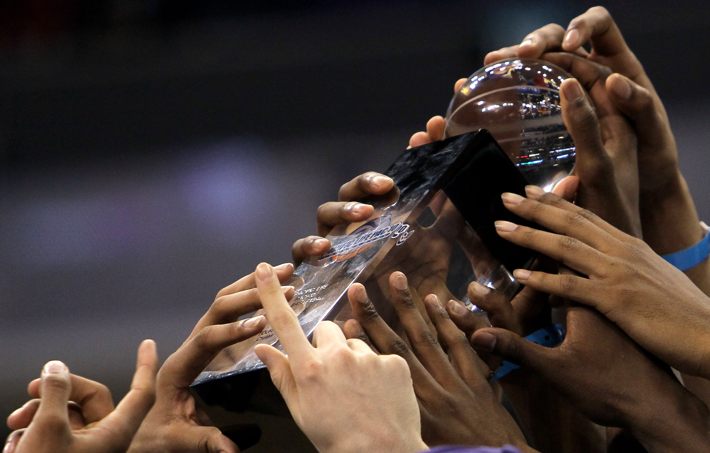 LOS ANGELES, CA - MARCH 13:  The Washington Huskies hold up the trophy the California Golden Bears after the championship game of the Pac-10 Basketball Tournament at Staples Center on March 13, 2010 in Los Angeles, California.   Washington won 79-75.  (Ph
