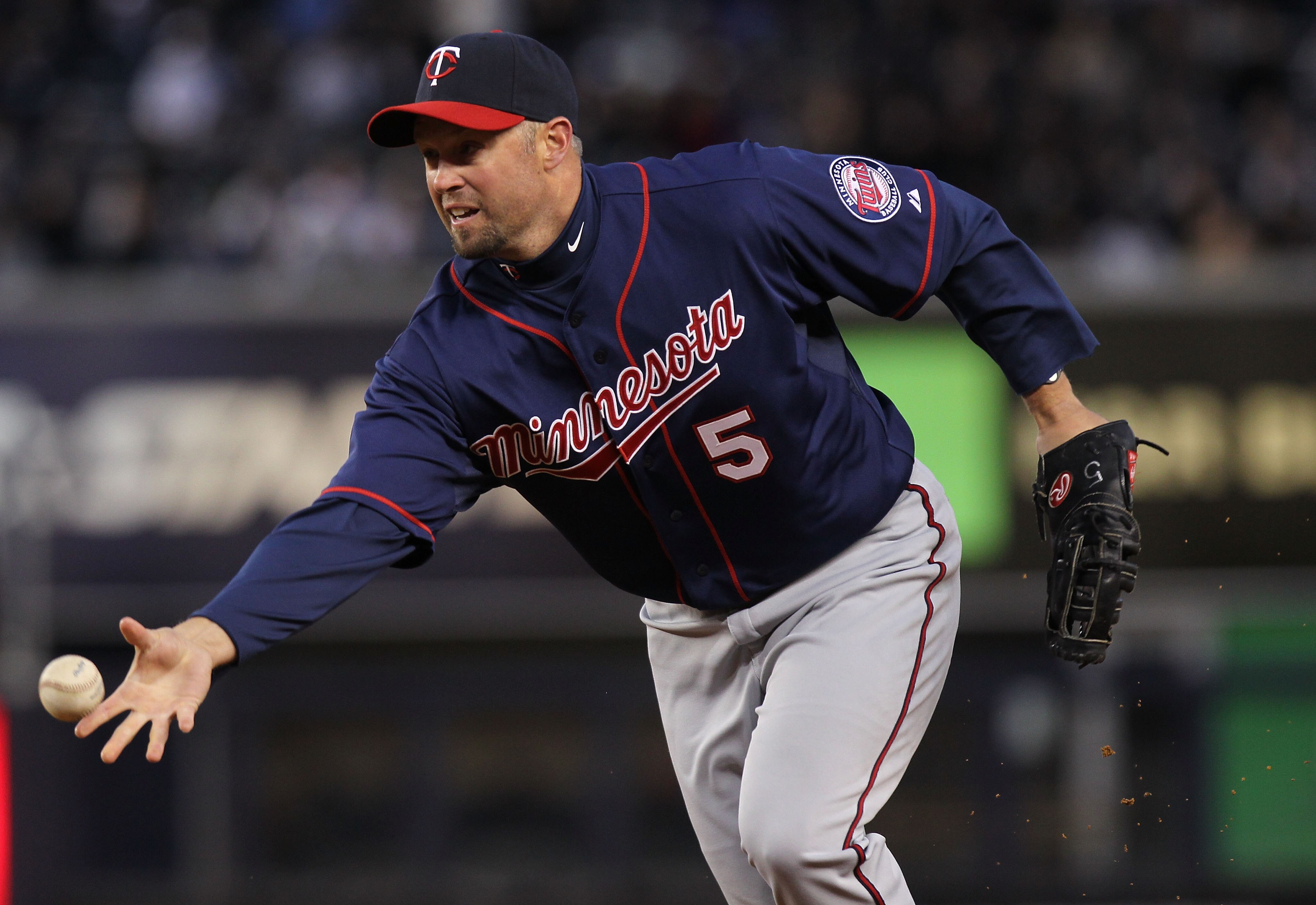 NEW YORK, NY - APRIL 05: Michael Cuddyer #5 of the Minnesota Twins tosses the ball to first against the New York Yankees at Yankee Stadium on April 5, 2011 in the Bronx borough of New York City.  (Photo by Nick Laham/Getty Images)