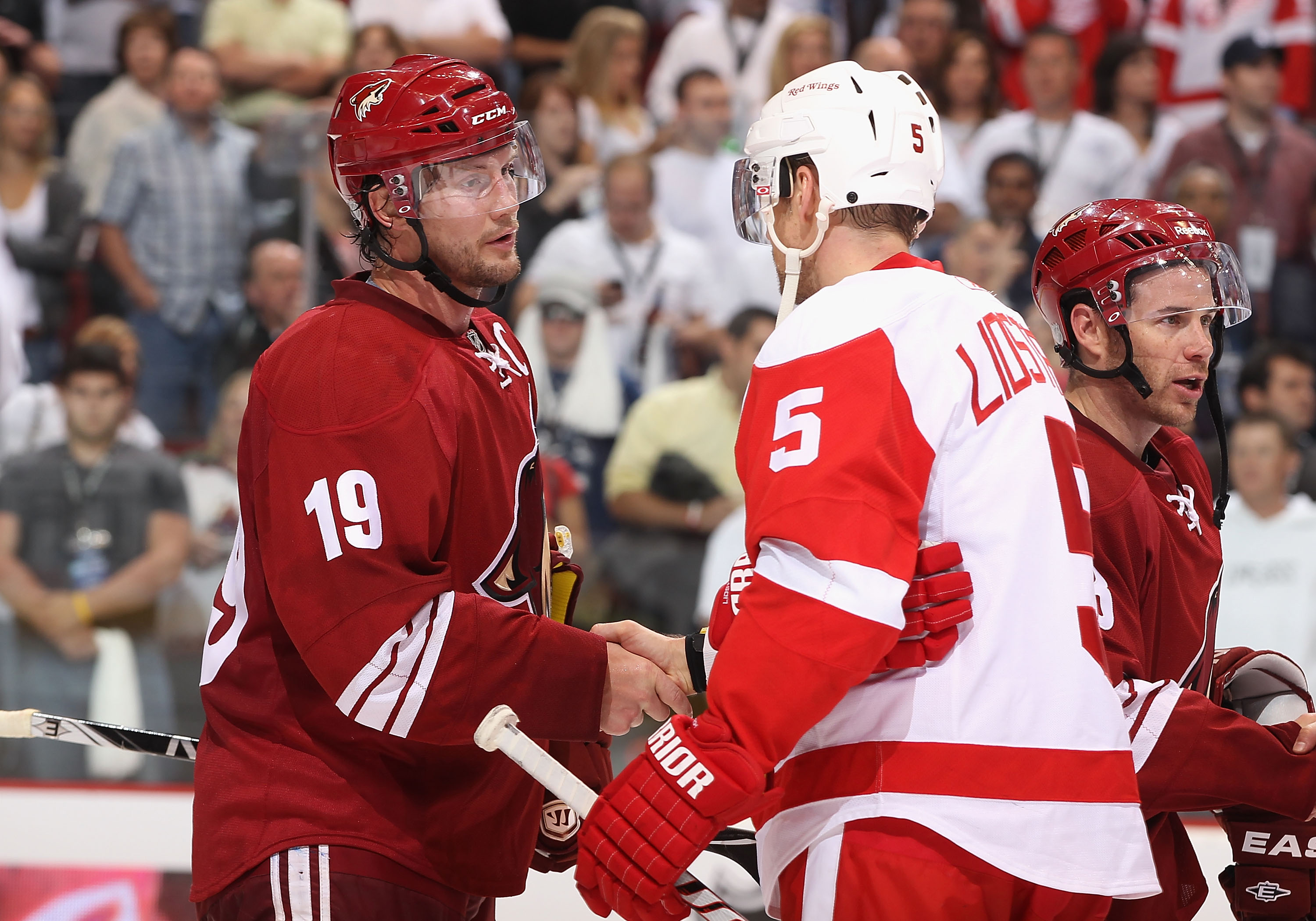 GLENDALE, AZ - APRIL 20:  Captains Shane Doan #19 of the Phoenix Coyotes and Nicklas Lidstrom #5 of the Detroit Red Wings shake hands following Game Four of the Western Conference Quarterfinals during the 2011 NHL Stanley Cup Playoffs at Jobing.com Arena