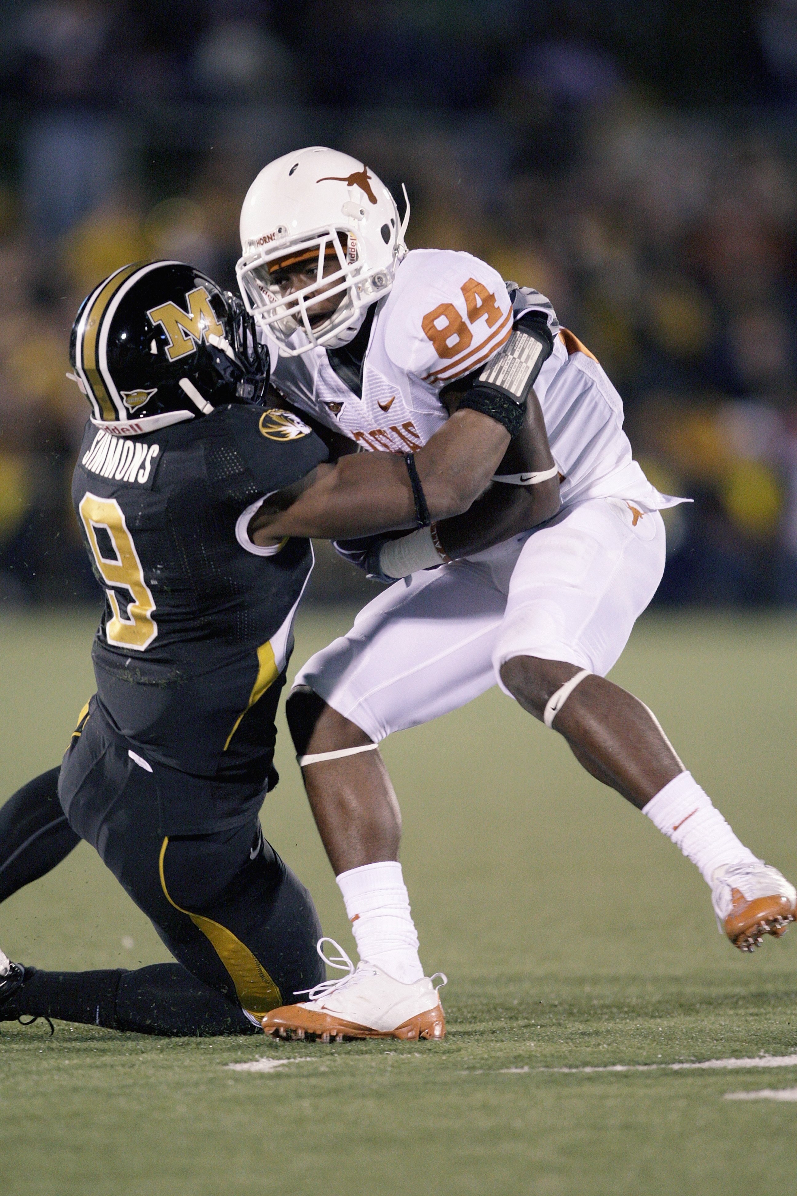 COLUMBIA, MO - OCTOBER 24:  Marquise Goodwin #84 of the Texas Longhorns is tackled by Jasper Simmons #9 of the Missouri Tigers on October 24, 2009 at Faurot Field/Memorial Stadium in Columbia, Missouri. (Photo by Jamie Squire/Getty Images)