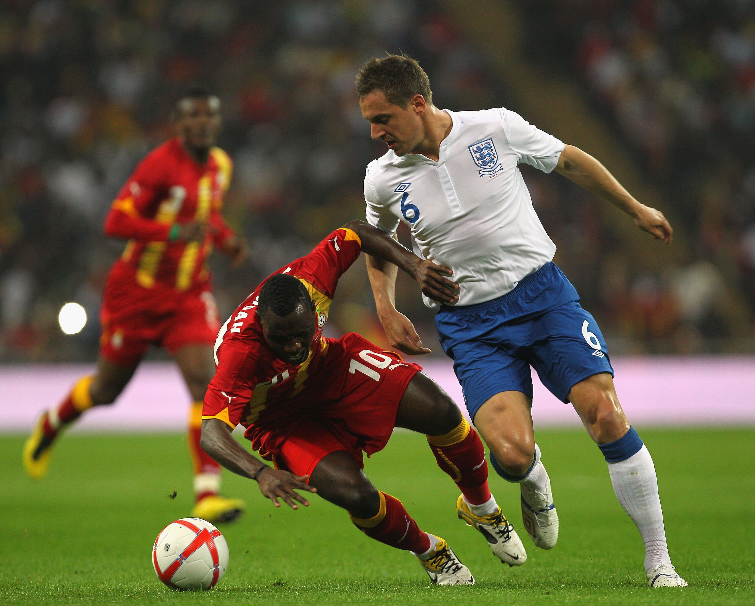 LONDON, ENGLAND - MARCH 29:  Phil Jagielka of England (R) tackles Kwadwo Asamoah of Ghana during the international friendly match between England and Ghana at Wembley Stadium on March 29, 2011 in London, England.  (Photo by Clive Rose/Getty Images)