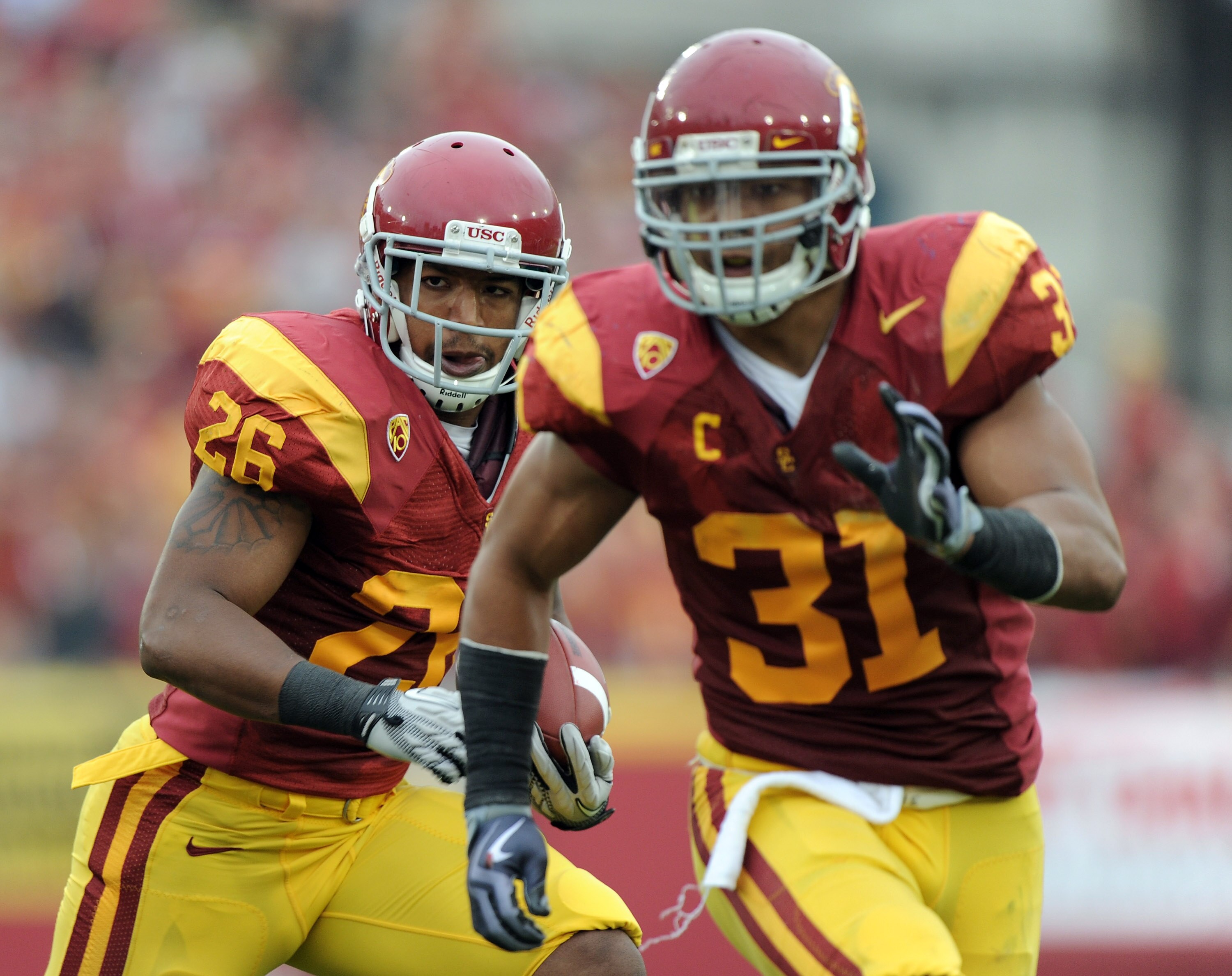 LOS ANGELES, CA - OCTOBER 16:  Marc Tyler #26 of the USC Trojans uses the block of Stanley Havilli #31 to score a touchdown for a 21-0 lead over the California Golden Bears during the second quarter at Los Angeles Memorial Coliseum on October 16, 2010 in 