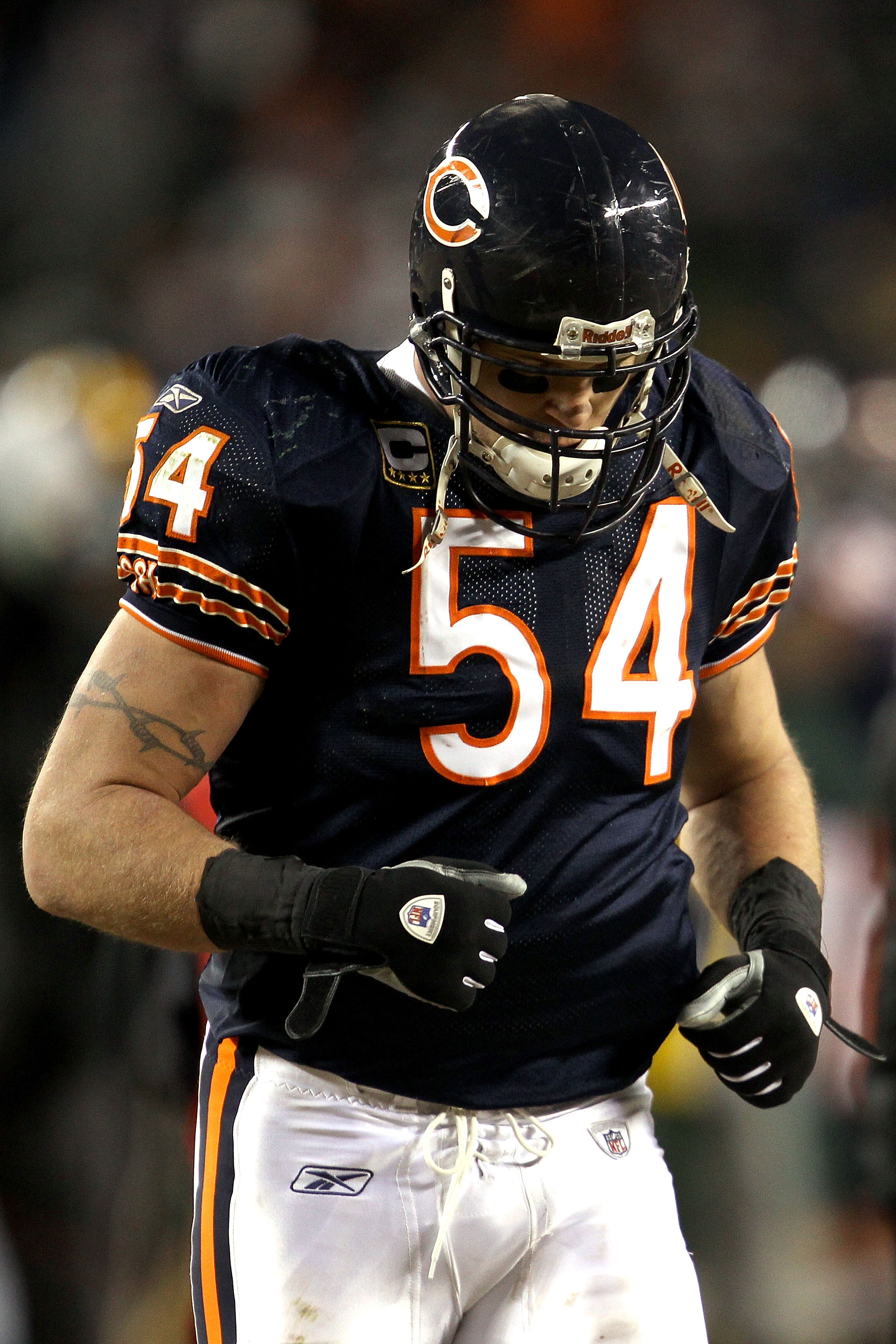 CHICAGO, IL - JANUARY 23:  Brian Urlacher #54 of the Chicago Bears runs off the field after the Bears 21-14 loss to the Green Bay Packers in the NFC Championship Game at Soldier Field on January 23, 2011 in Chicago, Illinois.  (Photo by Jonathan Daniel/Ge