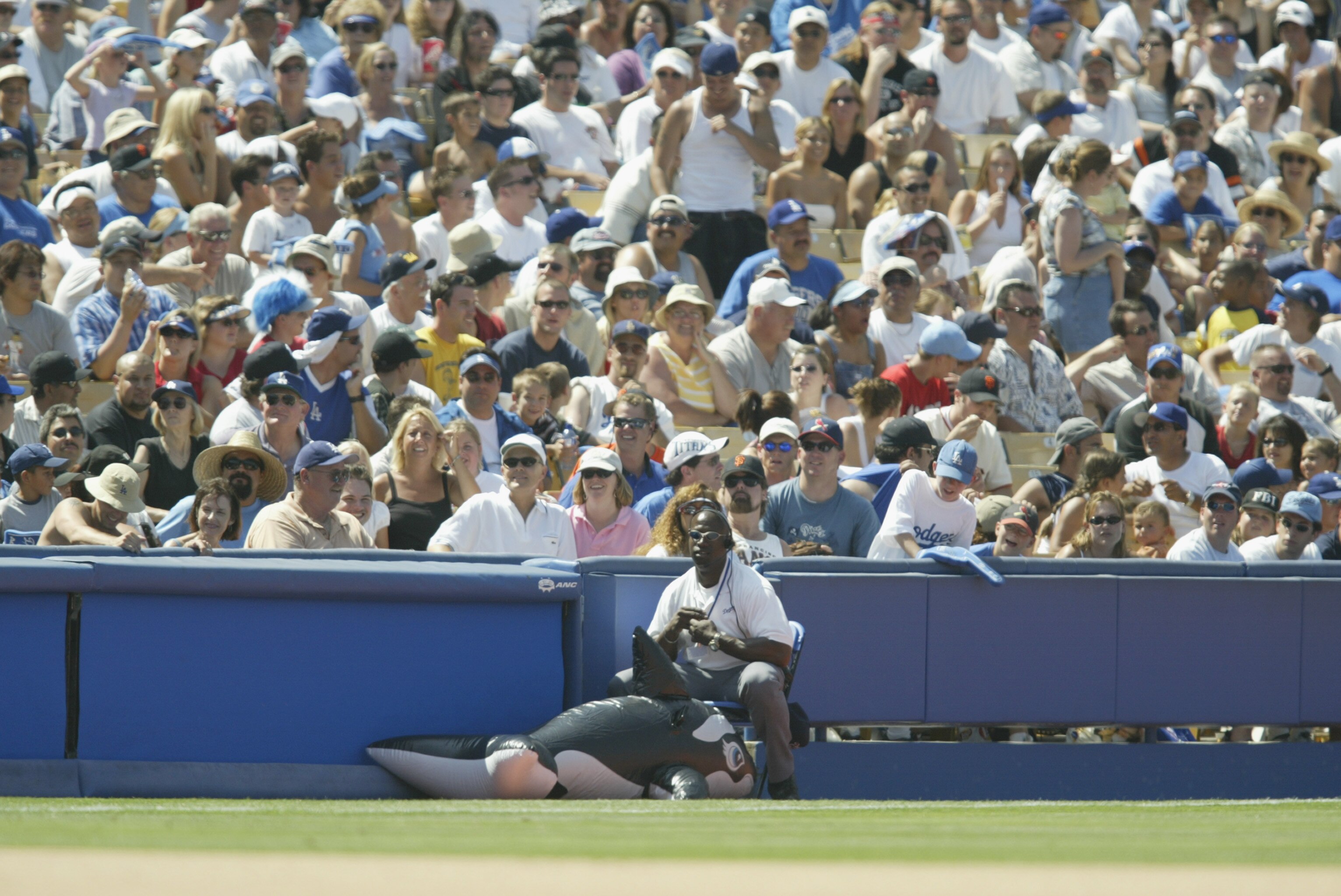LOS ANGELES - JULY 20:  An inflatable Shamu the Killer Whale toy rests with Los Angeles Dodger security in front of the third base side crowd during the MLB game between the San Francisco Giants and the Los Angeles Dodgers on July 20, 2002 at Dodger Stadi