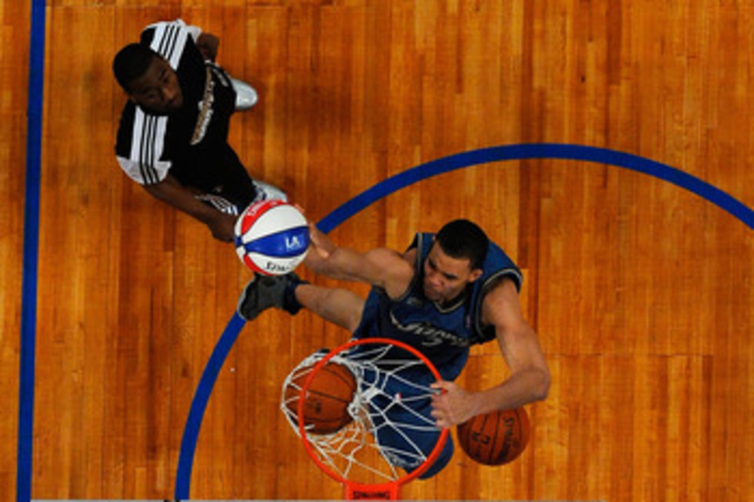 LOS ANGELES, CA - FEBRUARY 19:  JaVale McGee #34 of the Washington Wizards dunks three balls on the same jump after a pass from teammate John Wall #2 in the second round of the Sprite Slam Dunk Contest apart of NBA All-Star Saturday Night at Staples Cente