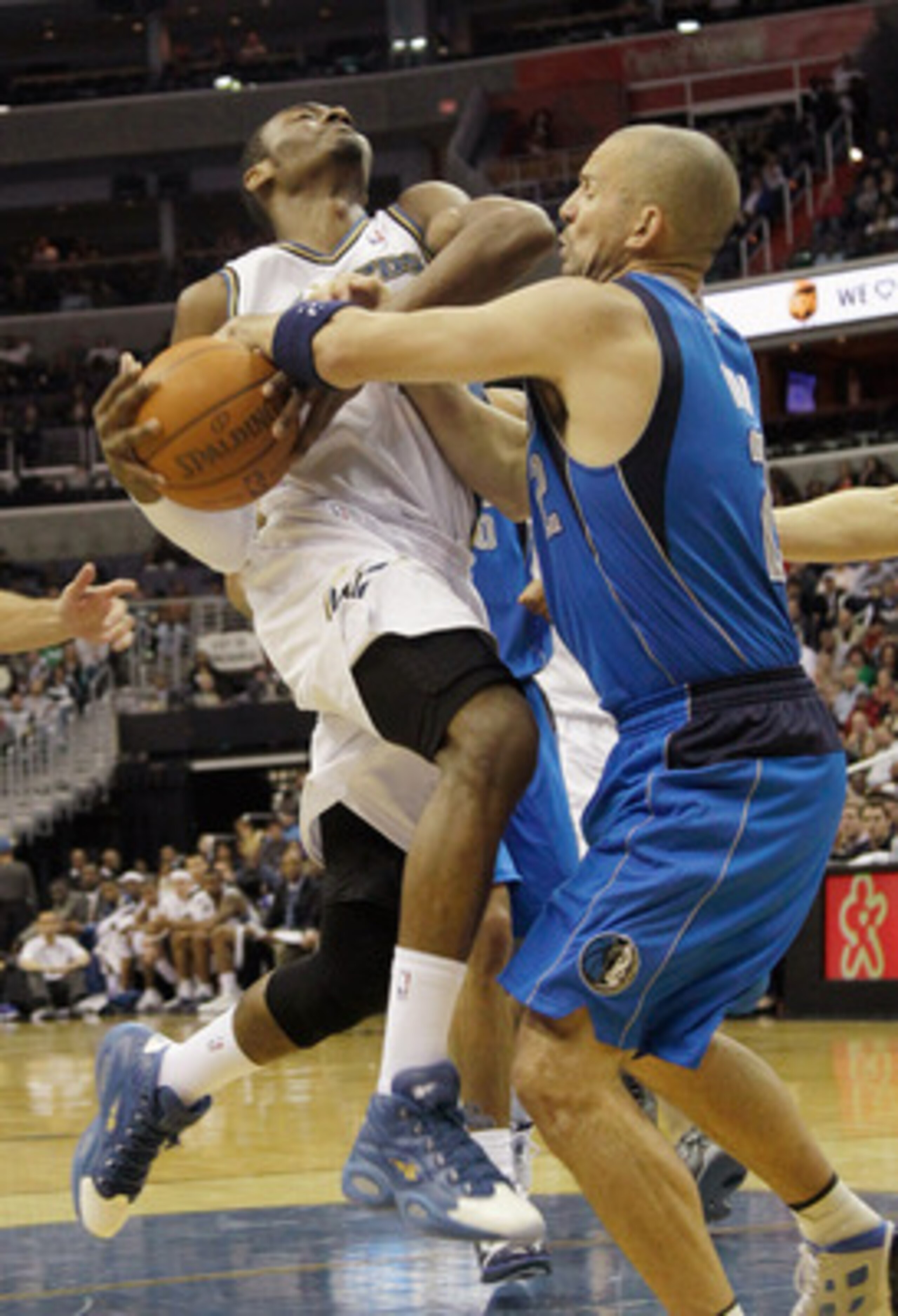 WASHINGTON, DC - FEBRUARY 26: John Wall #2 of the Washington Wizards is fouled by Jason Kidd #2 of the Dallas Mavericks during the second half at the Verizon Center on February 26, 2011 in Washington, DC. NOTE TO USER: User expressly acknowledges and agre