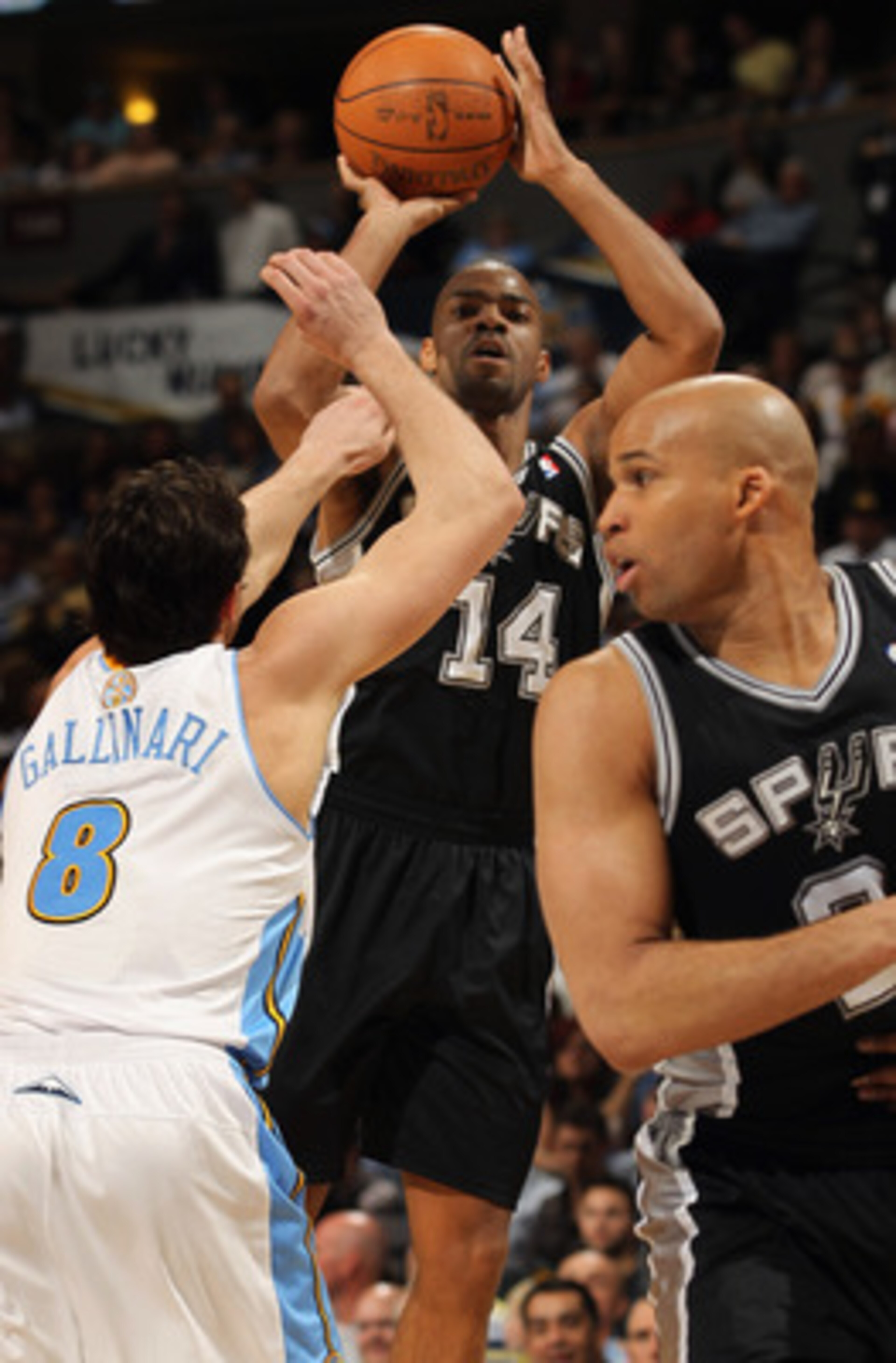 DENVER, CO - MARCH 23:  Gary Neal #14 of the San Antonio Spurs takes a shot over Danilo Gallinari #8 of the Denver Nuggets as Richard Jefferson #24 of the Spurs follows the play at the Pepsi Center on March 23, 2011 in Denver, Colorado. NOTE TO USER: User
