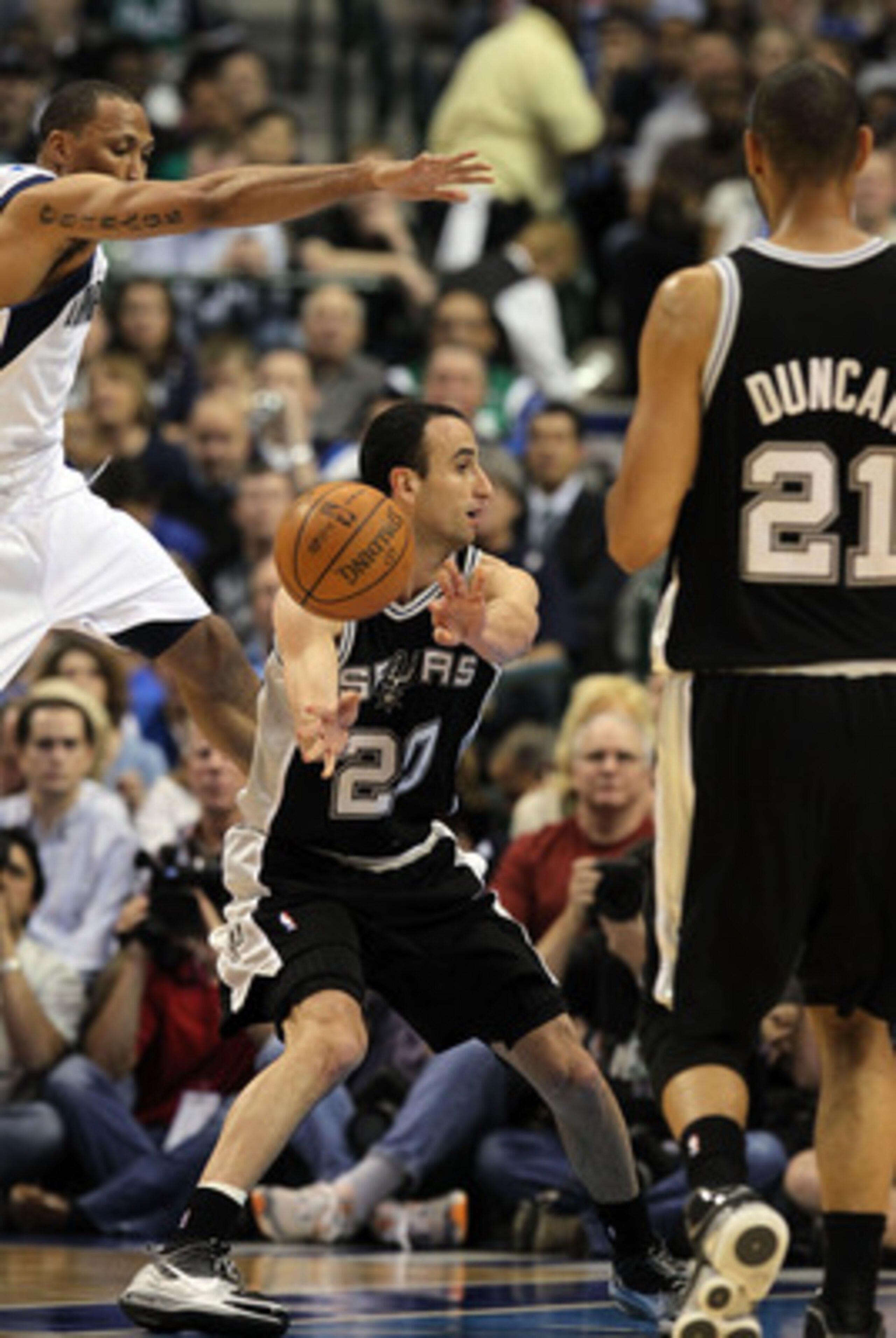 DALLAS - APRIL 21:  Guard Manu Ginobili #20 of the San Antonio Spurs passes the ball in front of Shawn Marion #0 of the Dallas Mavericks in Game Two of the Western Conference Quarterfinals during the 2010 NBA Playoffs at American Airlines Center on April