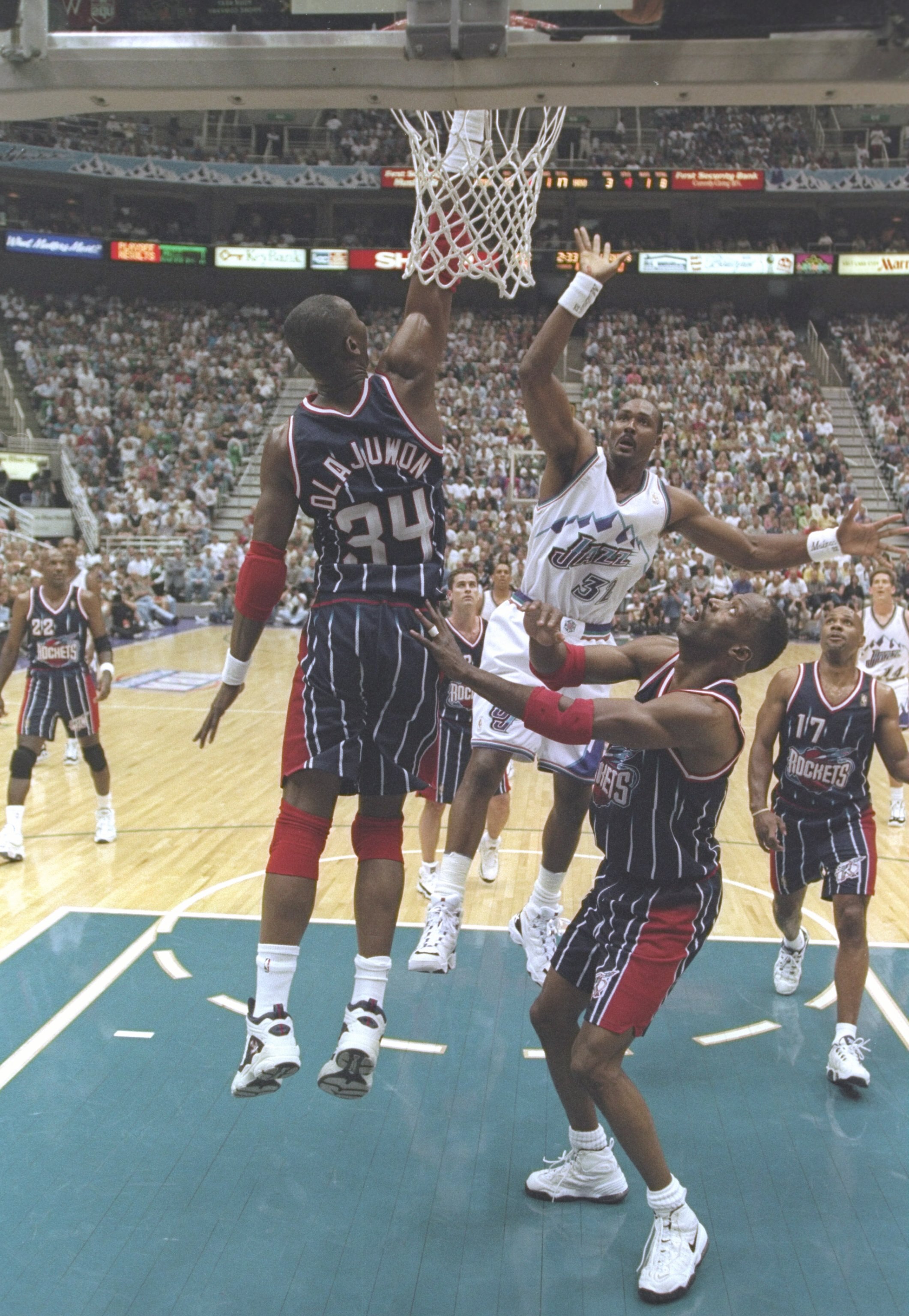 21 May 1997:  Forward Karl Malone of the Utah Jazz and center Hakeem Olajuwon and forward Kevin Willis of the Houston Rockets jump for the ball during a playoff game at the Delta Center in Salt Lake City, Utah.  The Jazz won the game 104-92. Mandatory Cre