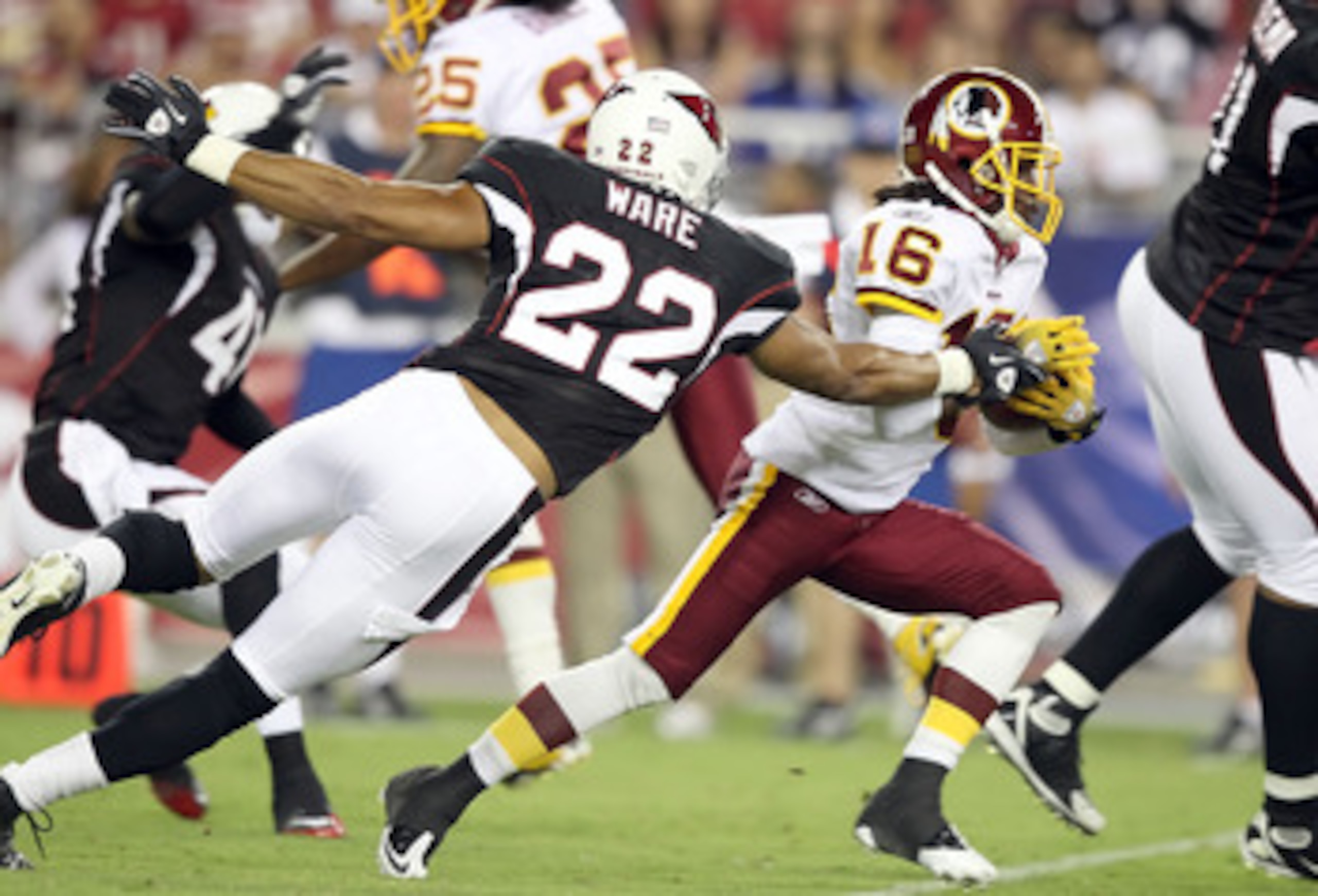 GLENDALE, AZ - SEPTEMBER 02:  Wide receiver Brandon Banks #16 of the Washington Redskins runs with the ball after a reception past Matt Ware #22 of the Arizona Cardinals during preseason NFL game at the University of Phoenix Stadium on September 2, 2010 i