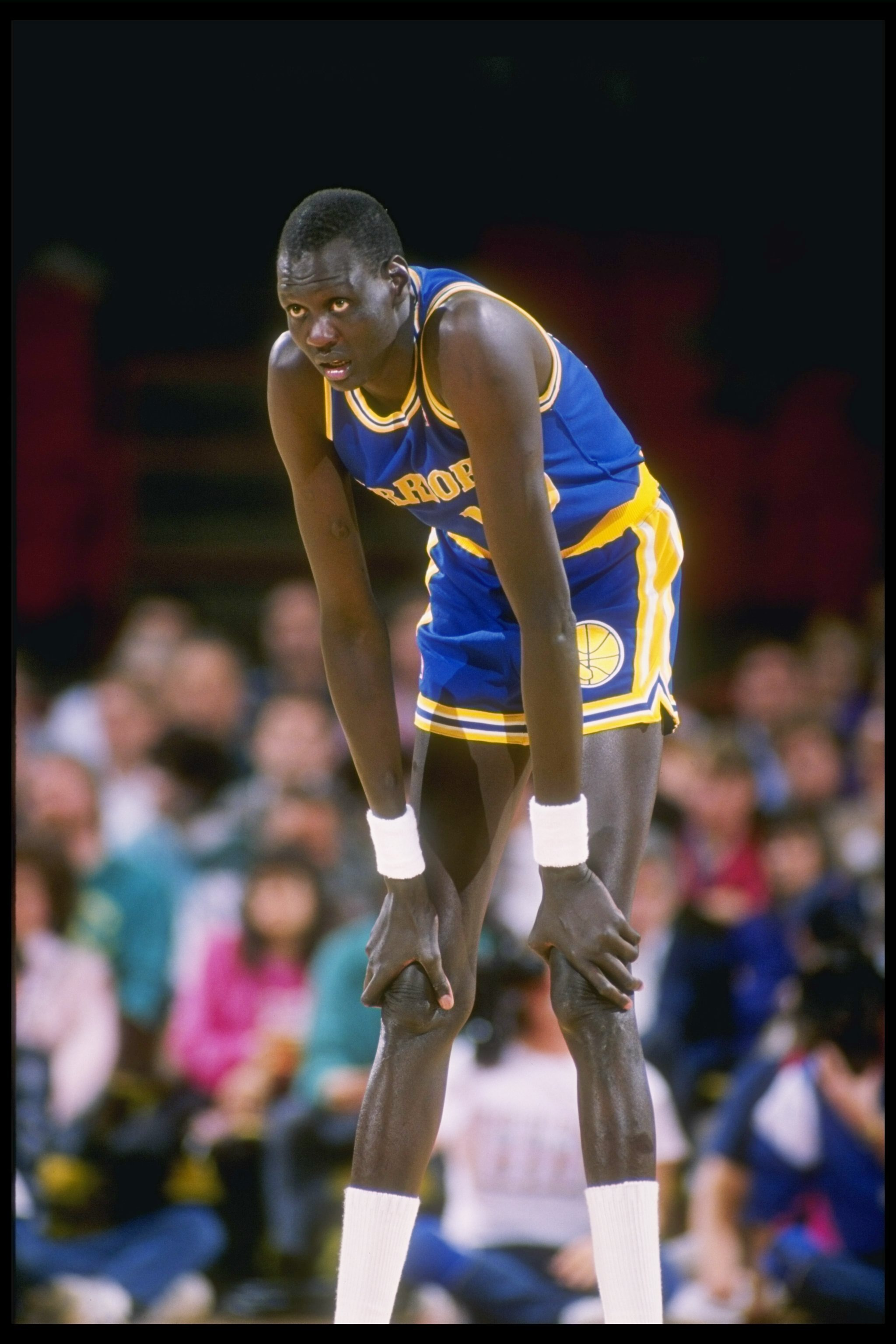 1989-1990:  Manute Bol of the Golden State Warriors looks on during a basketball game. Mandatory Credit: Tim de Frisco  /Allsport