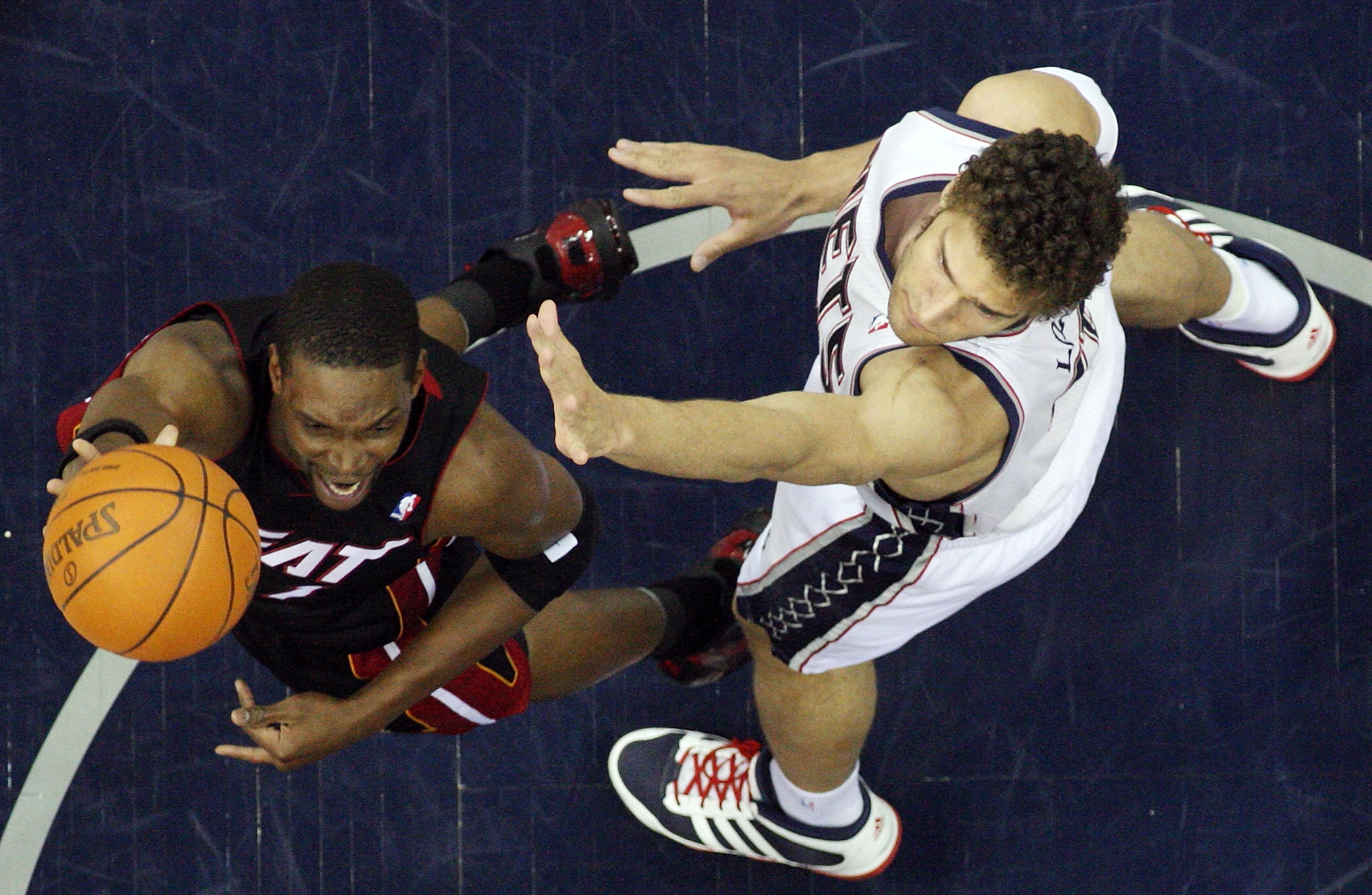 NEWARK, NJ - APRIL 03:  Chris Bosh #1 of the Miami Heat shoots against Brook Lopez #11 of the New Jersey Nets at the Prudential Center on April 3, 2011 in Newark, New Jersey.The Heat defeated the Nets 108-94.NOTE TO USER: User expressly acknowledges and a