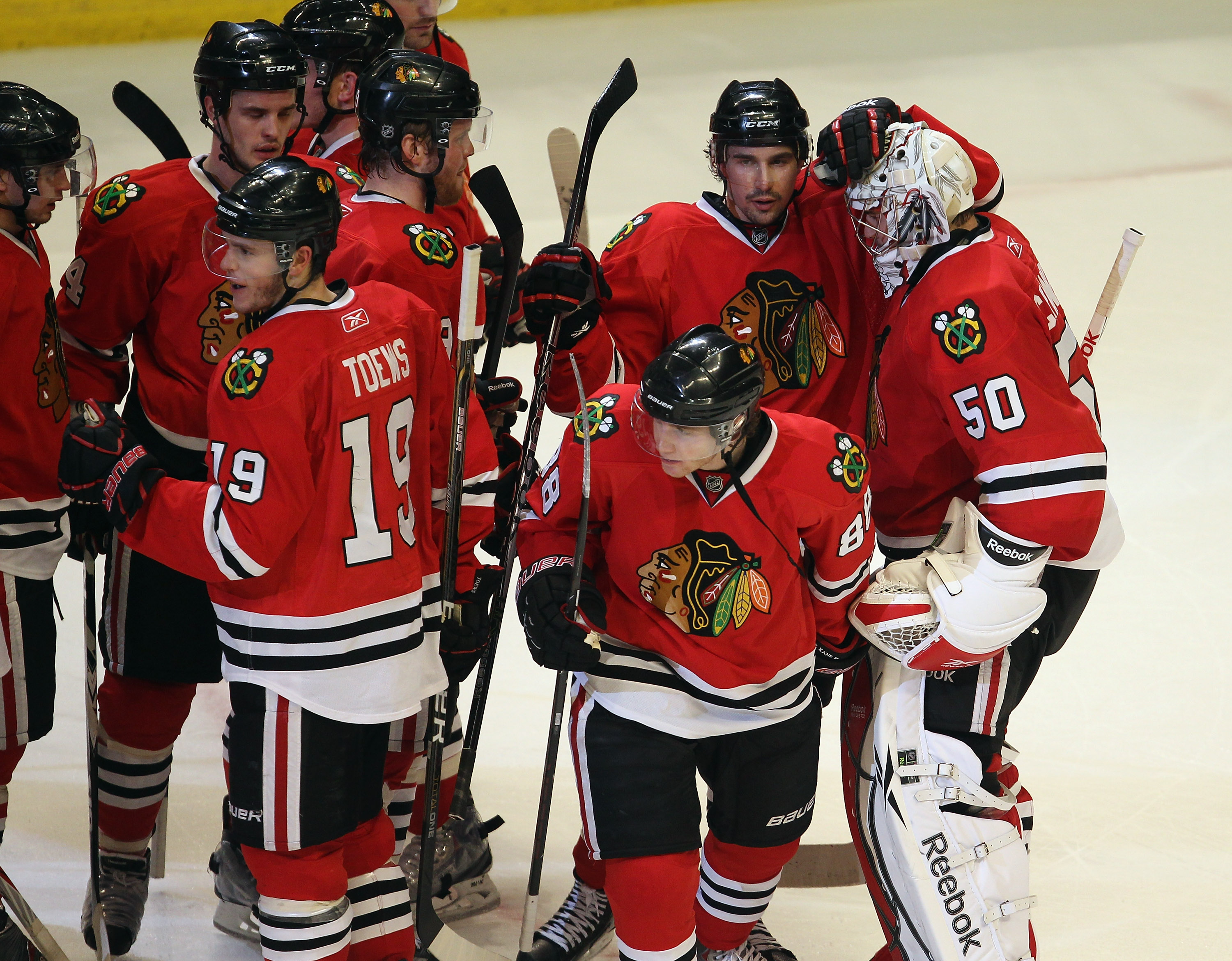 CHICAGO, IL - APRIL 19: Corey Crawford #50 of the Chicago Blackhawks is congratulated by teammates after a win over the Vancouver Canucks in Game Four of the Western Conference Quarterfinals during the 2011 NHL Stanley Cup Playoffs at the United Center on