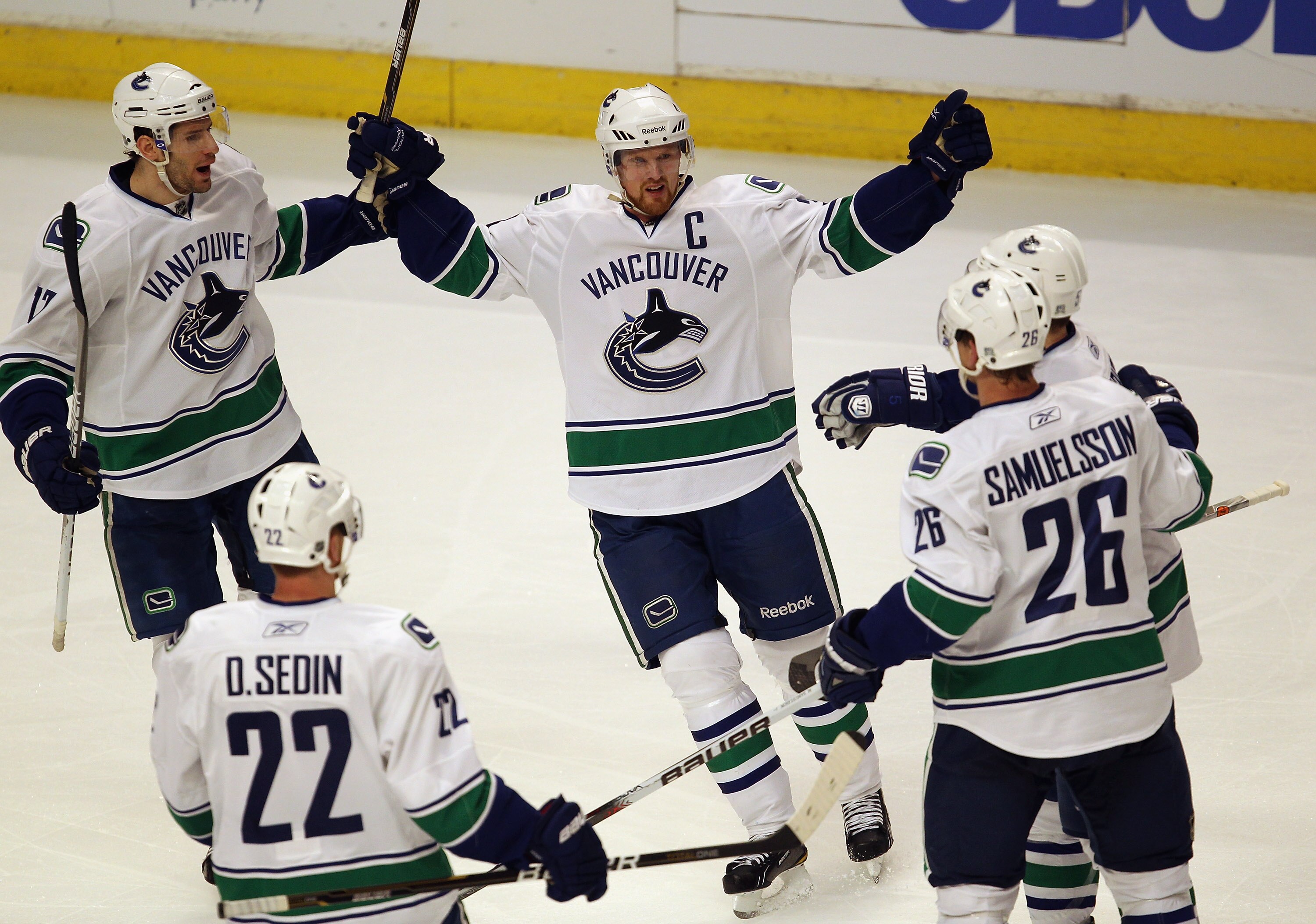 CHICAGO, IL - APRIL 17: (L-R) Ryan Kesler #17, Daniel Sedin #22, Henrik Sedin #33, Christian Ehrhoff #5 and Mikael Samuelsson #26 of the Vancouver Canucks celebrate a 2nd period goal against the Chicago Blackhawks in Game Three of the Western Conference Q