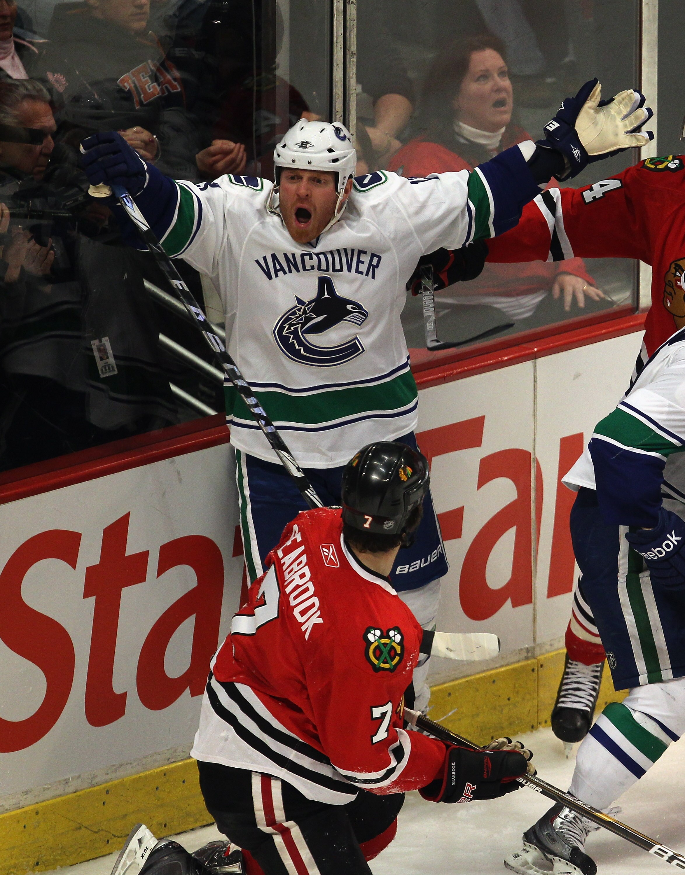 CHICAGO, IL - APRIL 17: Raffi Torres #13 of the Vancouver Canucks complains to a referee after hitting Brent Seabrook #7 of the Chicago Blackhawks in Game Three of the Western Conference Quarterfinals during the 2011 NHL Stanley Cup Playoffs at the United