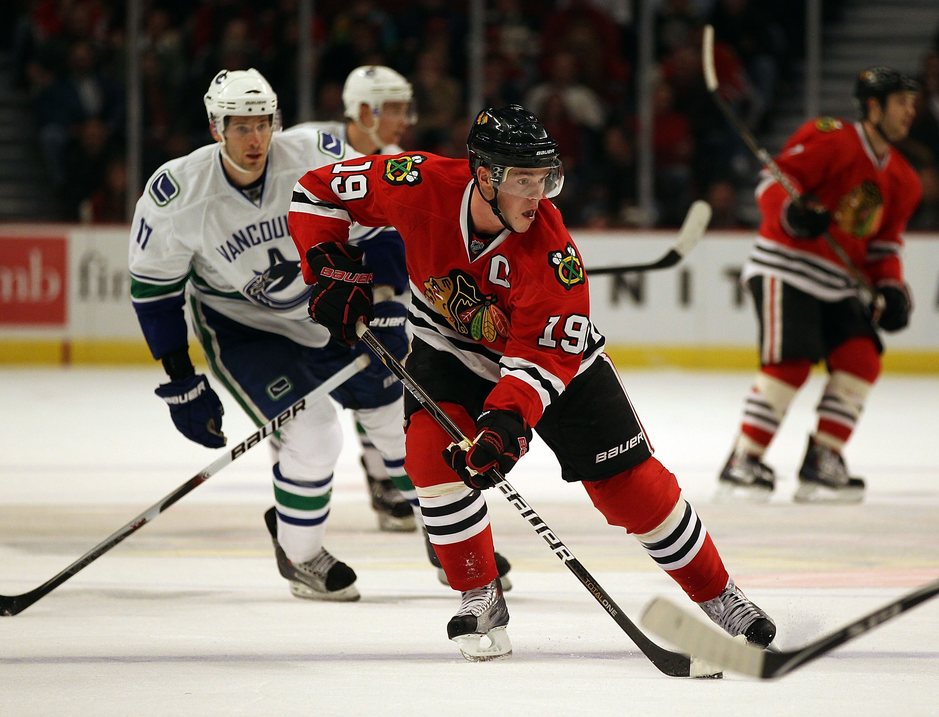CHICAGO, IL - DECEMBER 03: Jonathan Toews #19 of the Chicago Blackhawks skates up the ice past Ryan Kesler #17 of the Vancouver Canucks at the United Center on December 3, 2010 in Chicago, Illinois. The Canucks defeated the Blackhawks 3-0. (Photo by Jonat