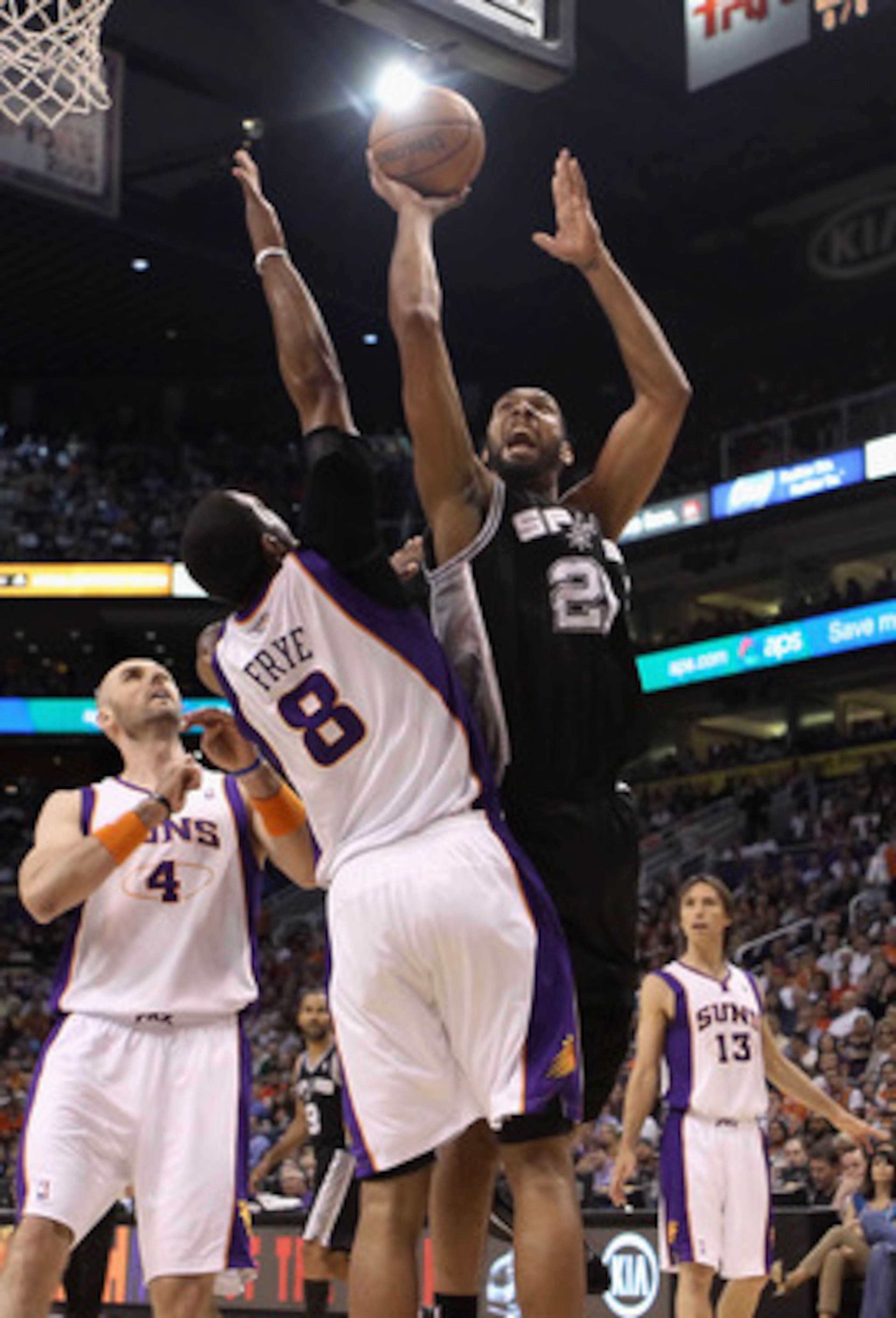 PHOENIX, AZ - APRIL 13:  Tim Duncan #21 of the San Antonio Spurs puts up a shot over Channing Frye #8 of the Phoenix Suns during the NBA game at US Airways Center on April 13, 2011 in Phoenix, Arizona.  NOTE TO USER: User expressly acknowledges and agrees