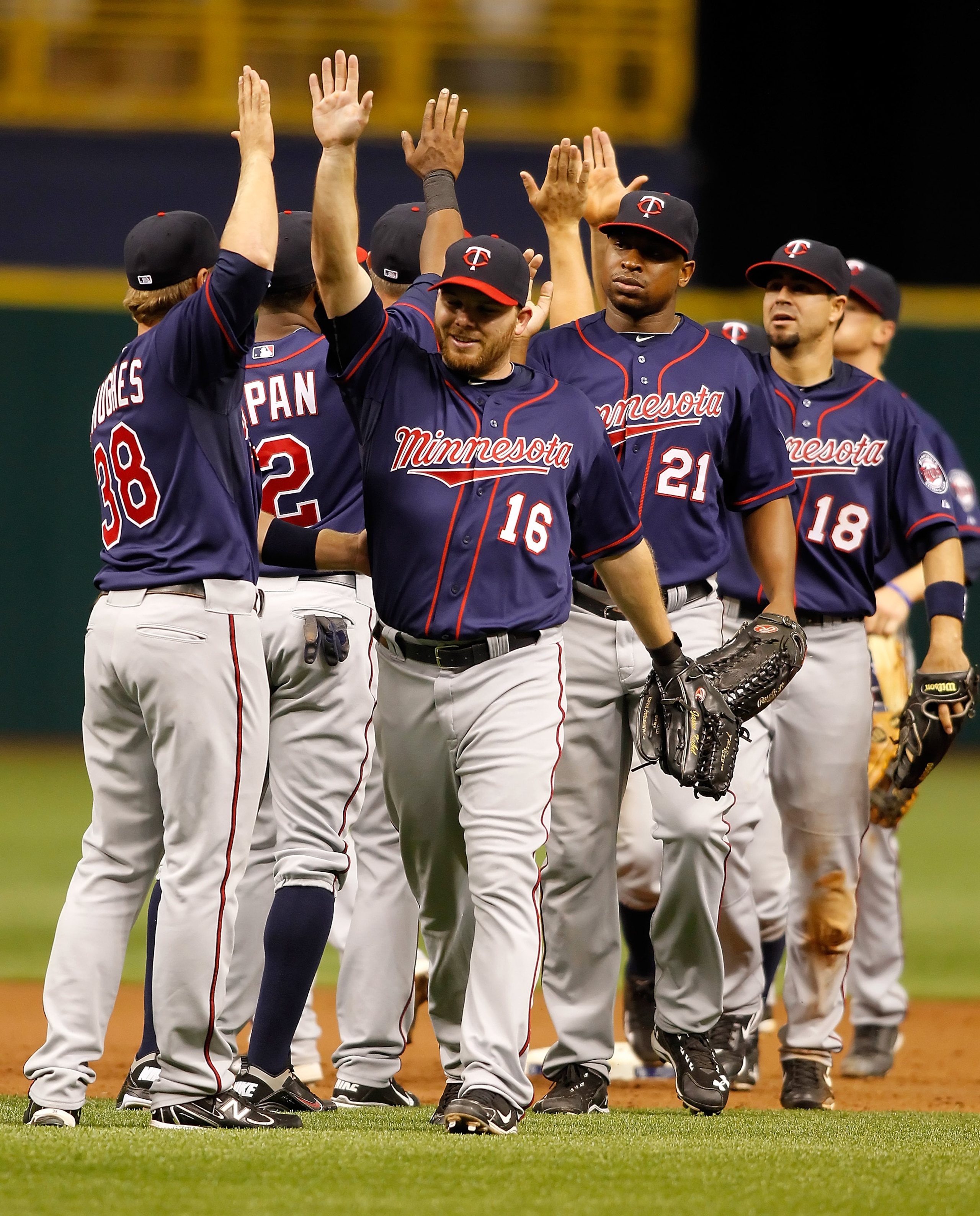 ST. PETERSBURG, FL - APRIL 17:  Jason Kubel #16 of the Minnesota Twins is congratulated by his teammates after their victory over the Tampa Bay Rays at Tropicana Field on April 17, 2011 in St. Petersburg, Florida.  (Photo by J. Meric/Getty Images)