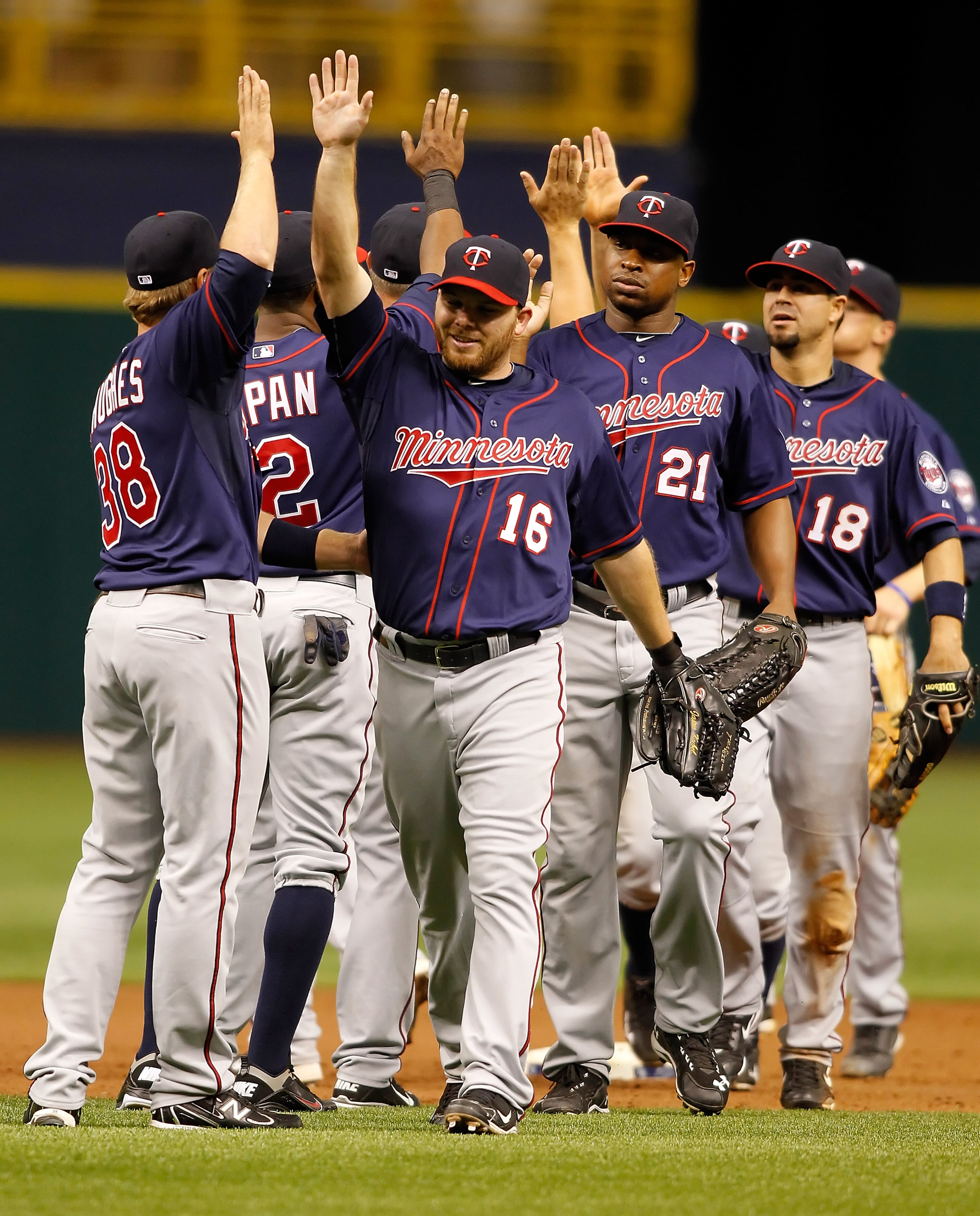 ST. PETERSBURG, FL - APRIL 17:  Jason Kubel #16 of the Minnesota Twins is congratulated by his teammates after their victory over the Tampa Bay Rays at Tropicana Field on April 17, 2011 in St. Petersburg, Florida.  (Photo by J. Meric/Getty Images)