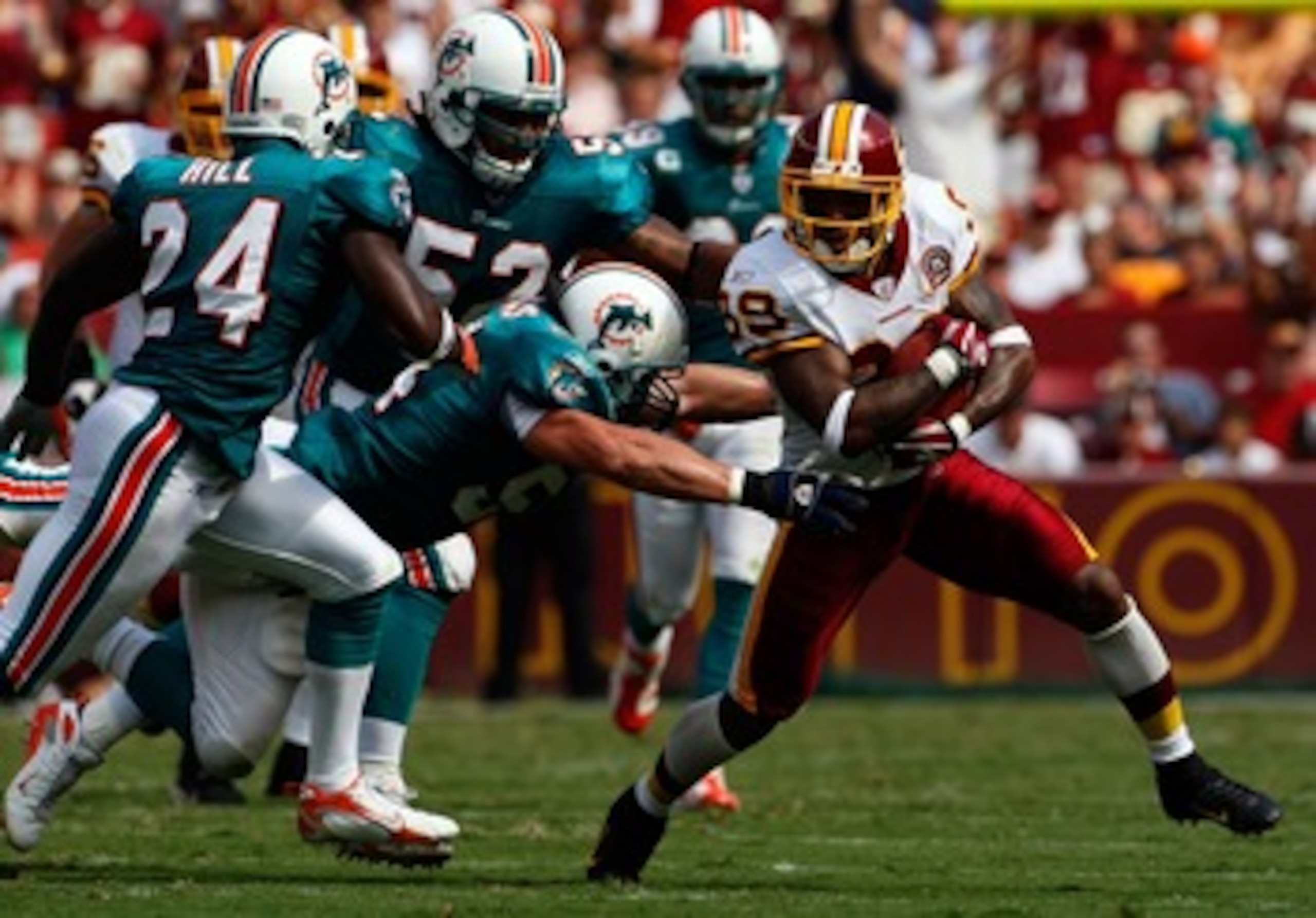 WASHINGTON - SEPTEMBER 09:  Wide receiver Santana Moss #89 of the Washington Redskins is gang tackled by Miami Dolphins defense in third quarter action at FedEx Field September 9, 2007 in Landover, Maryland.  The Redskins defeated the Dolphins 16-13.  (Ph