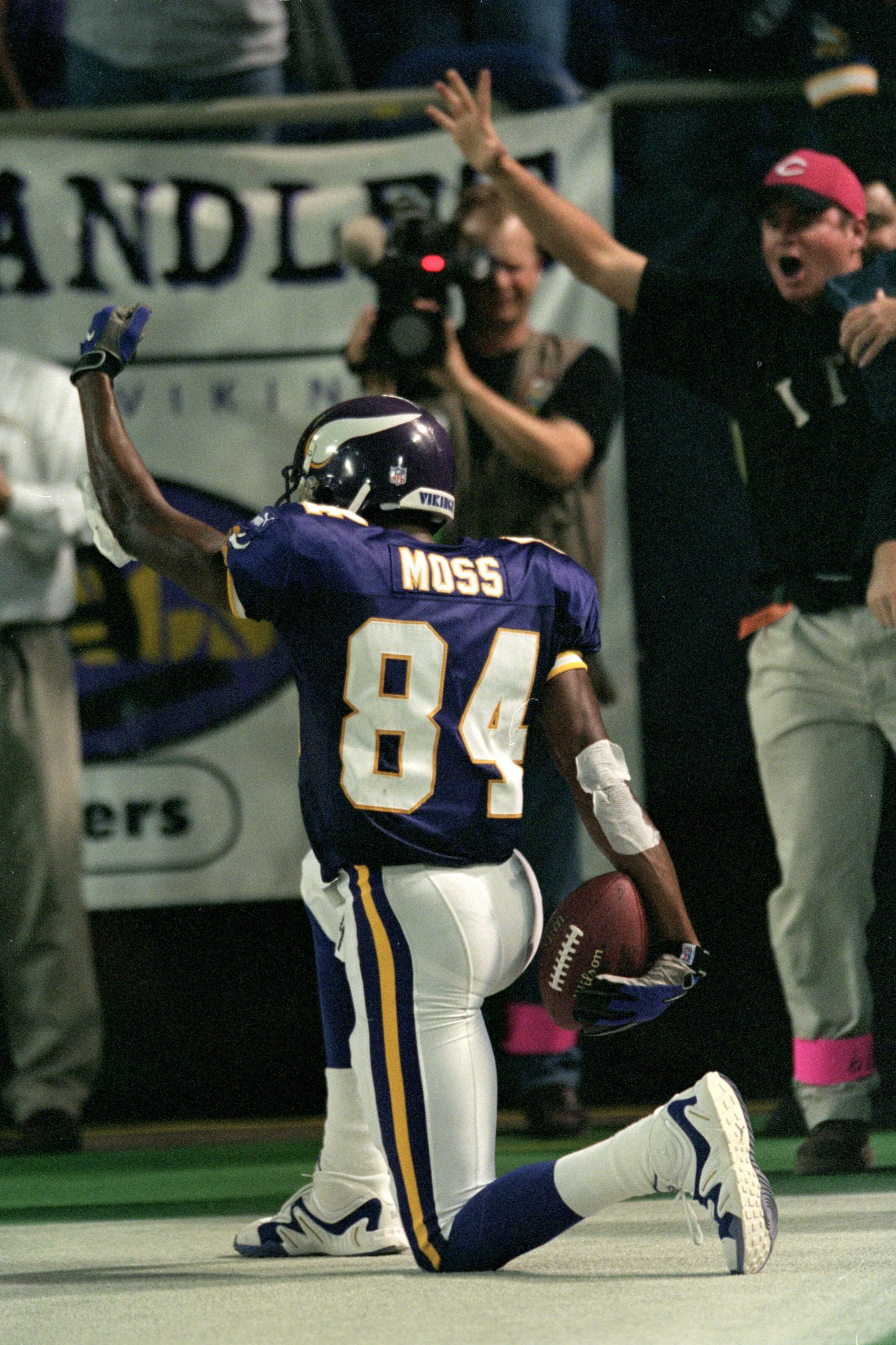 8 Nov 1999:  Randy Moss #84 of the Minnesota Vikings kneels and celebrates after he makes a touch down during the game against the Dallas Cowboys at the Herbert H. Humphery Metrodome in Minneapolis, Minnesota. The Vikings defeated the Cowboys 27-17. Manda