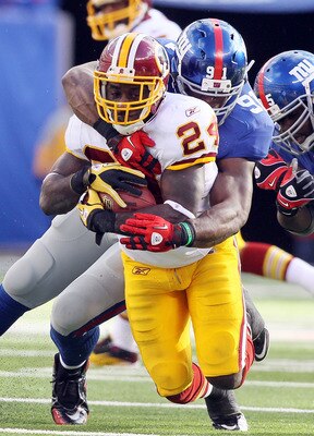 EAST RUTHERFORD, NJ - DECEMBER 05:  James Davis #24 of the Washington Redskins is tackled by Justin Tuck #91 of the New York Giants on December 5, 2010 at the New Meadowlands Stadium in East Rutherford, New Jersey.  (Photo by Jim McIsaac/Getty Images)