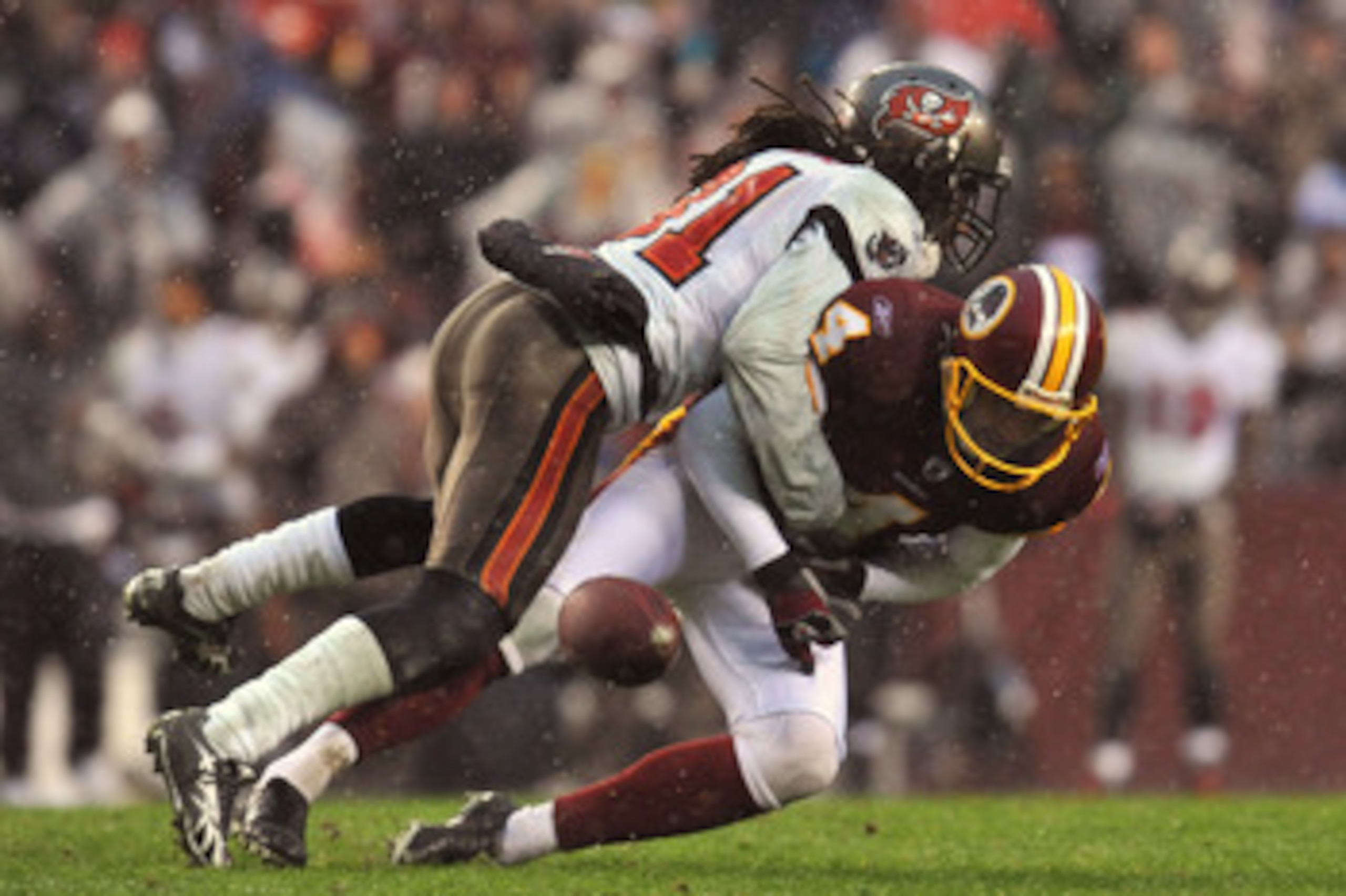 LANDOVER, MD - DECEMBER 12:  E.J. Biggers #31 of the Tampa Bay Buccaneers causes Graham Gano #4 of the Washington Redskins to fumble after a missed snap on an extra point attempt that would have tied the game with seconds remaining in the fourth quarter a