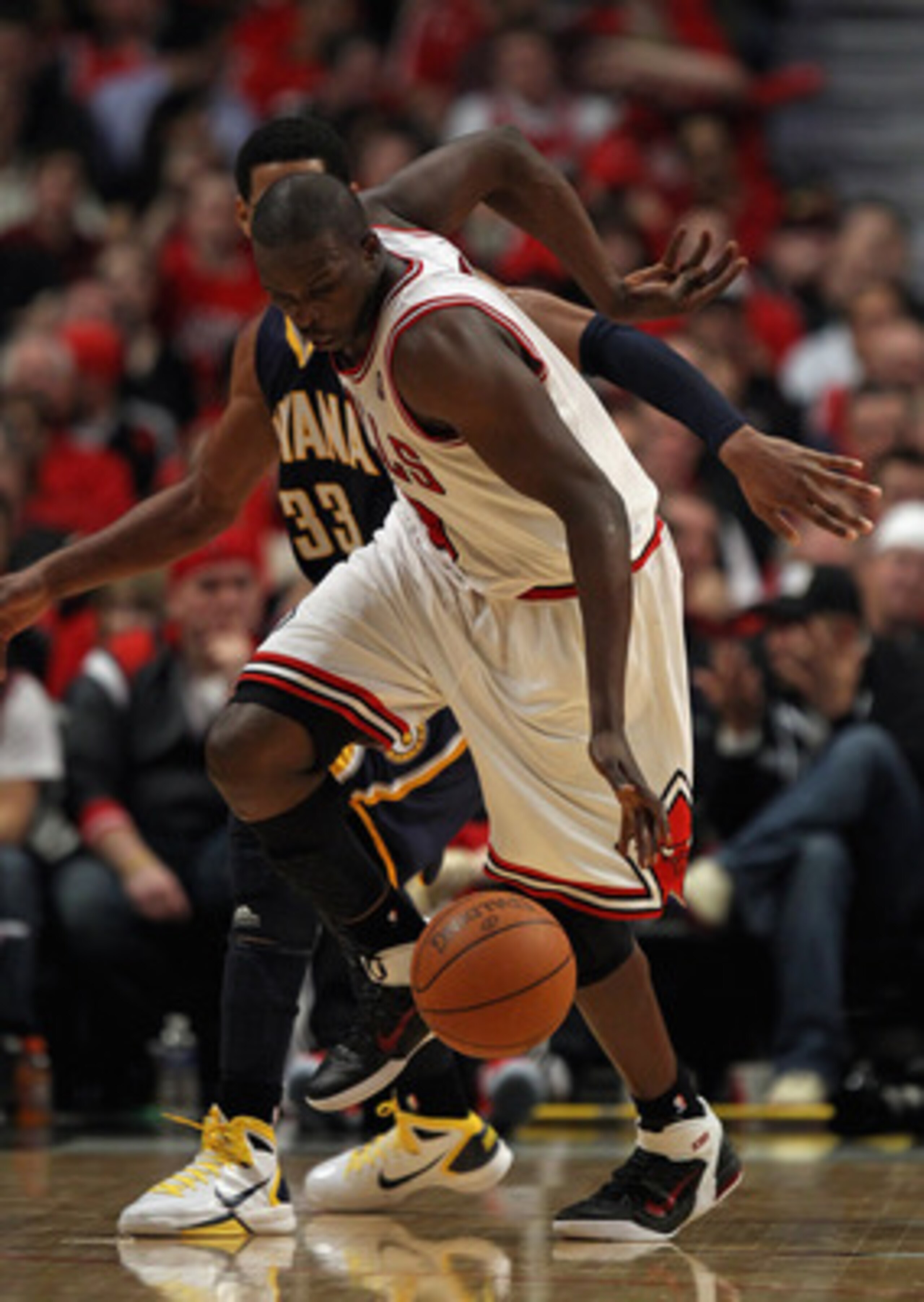 CHICAGO, IL - APRIL 18: Loul Deng #9 of the Chicago Bulls chases down the ball after stripping Danny Granger #33 of the Indiana Pacers in Game Two of the Eastern Conference Quarterfinals in the 2011 NBA Playoffs at the United Center on April 18, 2011 in C