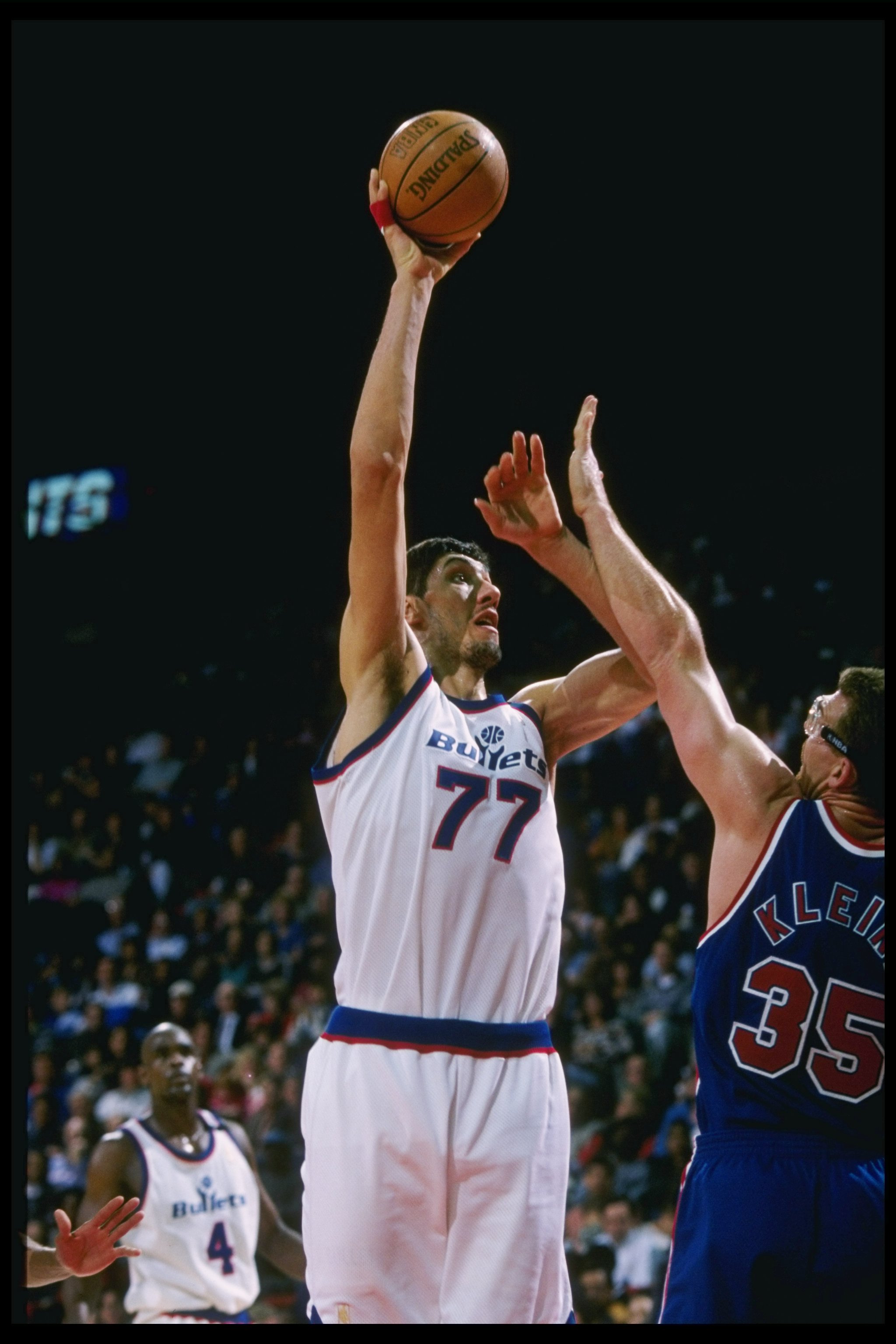 11 Apr 1997:  Gheorghe Muresan #77 of the Washington Bullets shoots over Joe Kleine #35 of the New Jersey Nets during their 109-90 win over the Nets at the USAir Arena in Landover, Maryland.  Mandatory Credit: Doug Pensinger  /Allsport