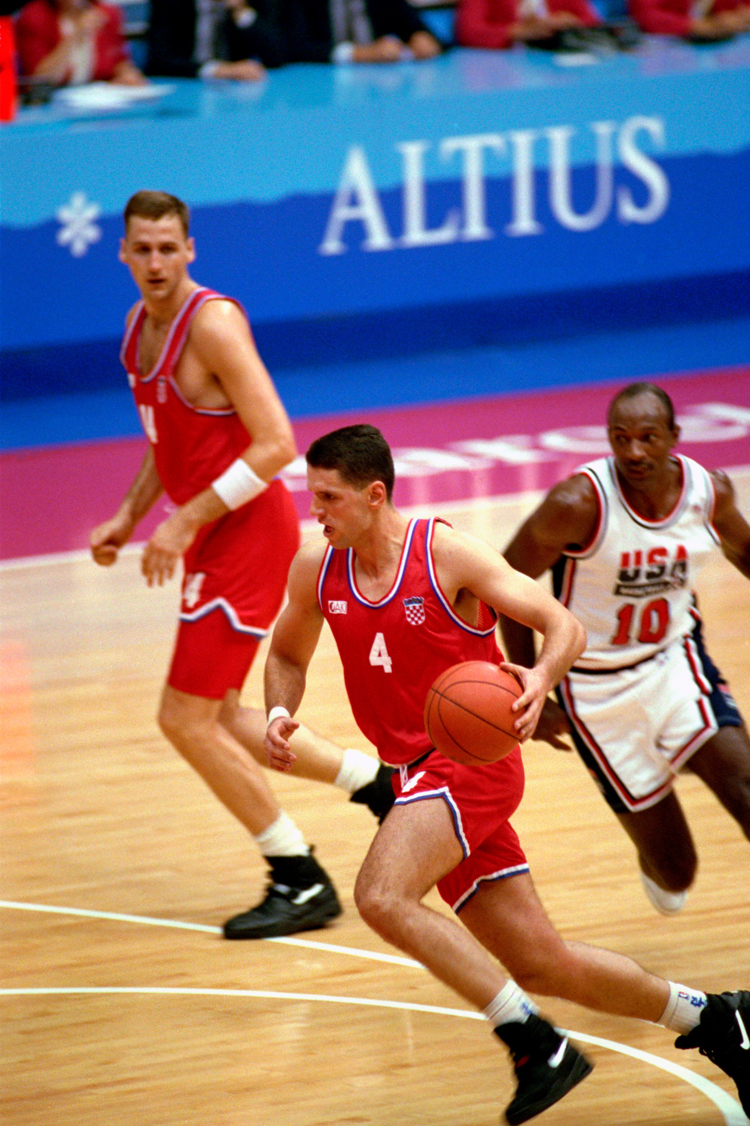 BARCELONA, SPAIN - AUGUST 8:  Drazen Petrovic #4 of Croatia moves the ball past Clyde Drexler #10 of the United States in the 1992 Olympic game on August 8, 1992 in Barcelona, Spain. The 'Dream Team' defeated Croatia 117-85. NOTE TO USER: User expressly a