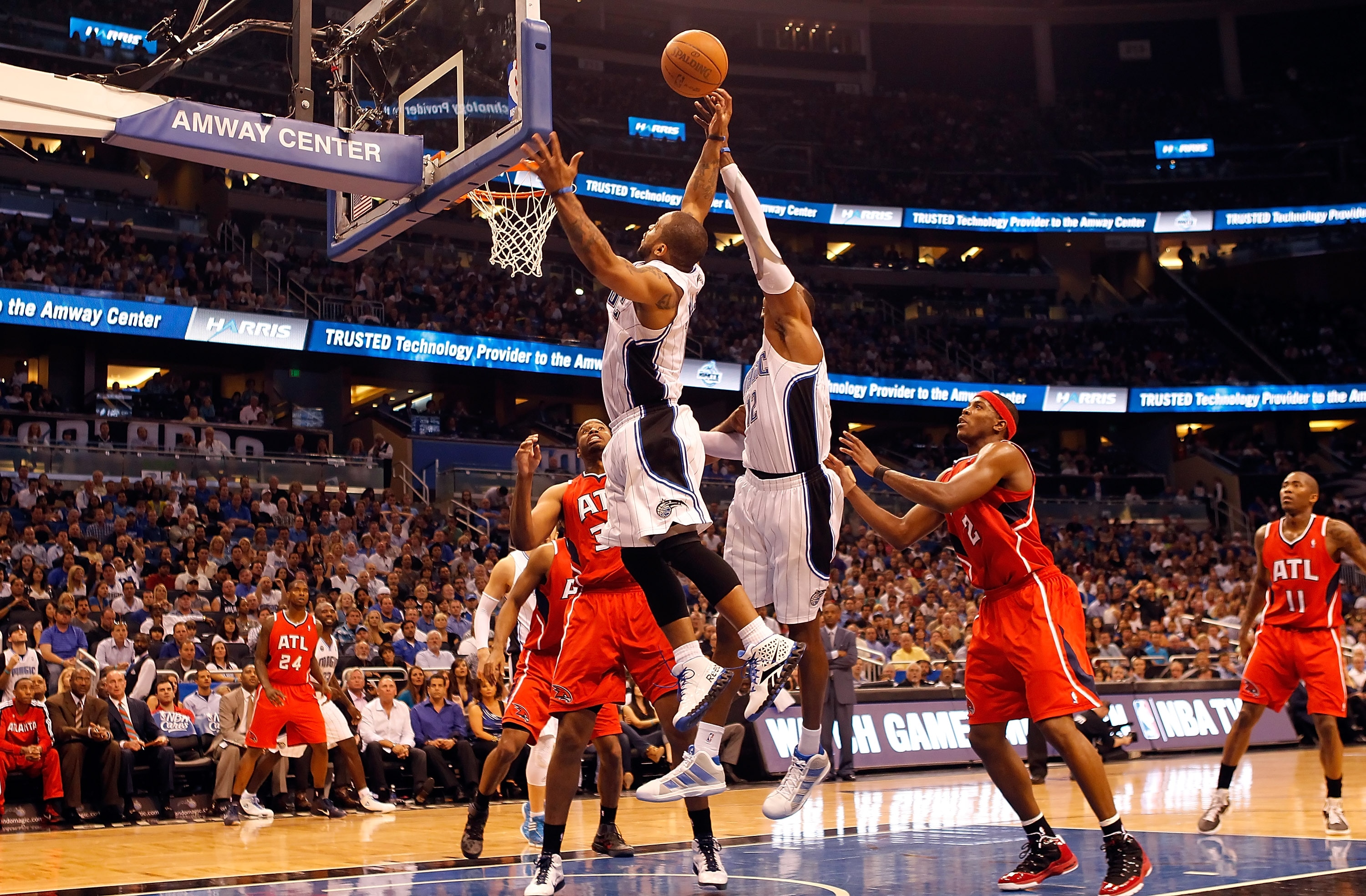 ORLANDO, FL - APRIL 16:  Jameer Nelson #14 (left) and Dwight Howard #12 of the Orlando Magic battle for a rebound against the Atlanta Hawks during Game One of the Eastern Conference Quarterfinals of the 2011 NBA Playoffs on April 16, 2011 at the Amway Are
