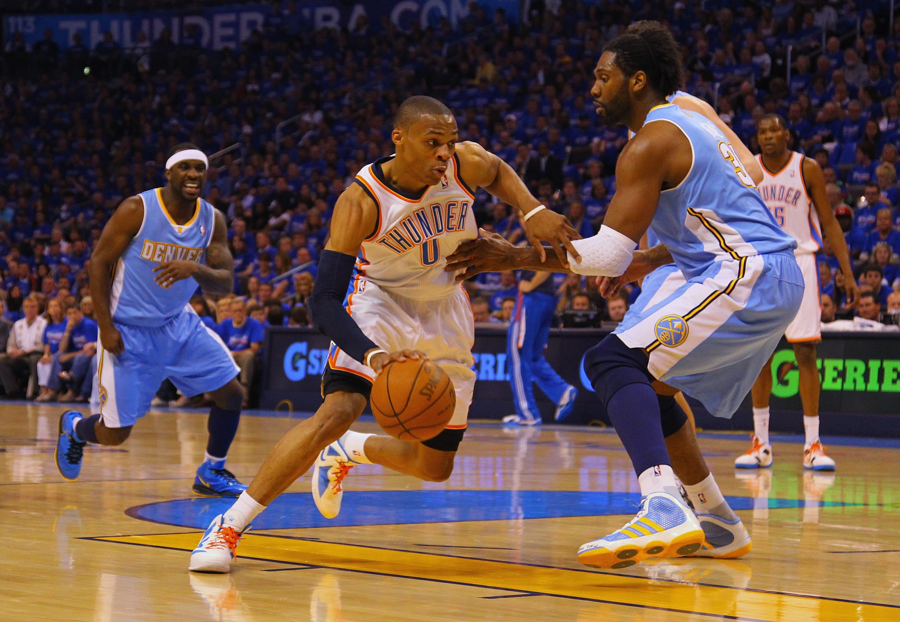 OKLAHOMA CITY, OK - APRIL 17: Russell Westbrook #0 of the Oklahoma City Thunder drives to the basket against Nene #31 of the Denver Nuggets in Game One of the Western Conference Quarterfinals in the 2011 NBA Playoffs on April 17, 2011 at the Ford Center i