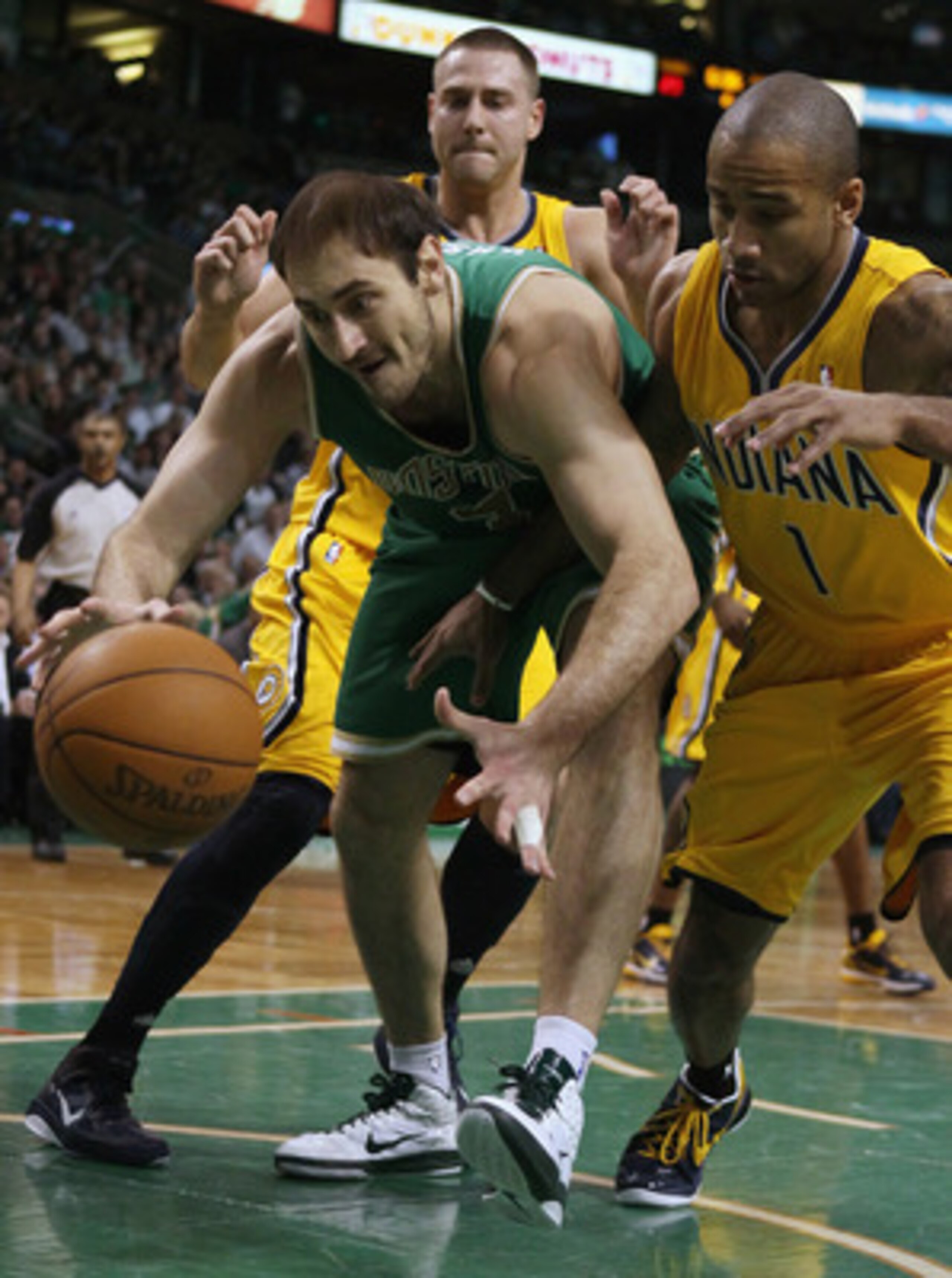 BOSTON, MA - MARCH 16:  Nenad Krstic #4 of the Boston Celtics tries to hang on to the ball as Dahntay Jones #1 of the Indiana Pacers defends on March 16, 2011 at the TD Garden in Boston, Massachusetts.  NOTE TO USER: User expressly acknowledges and agrees